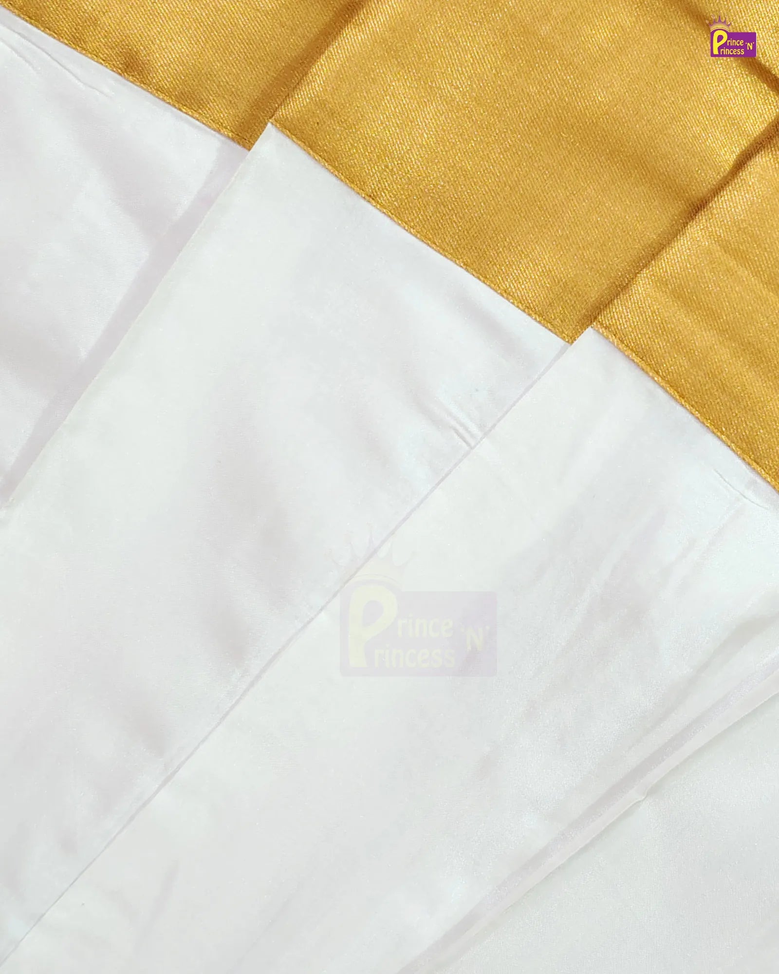 A close-up of a white fabric with a wide gold border, showing the texture and sheen of the material.