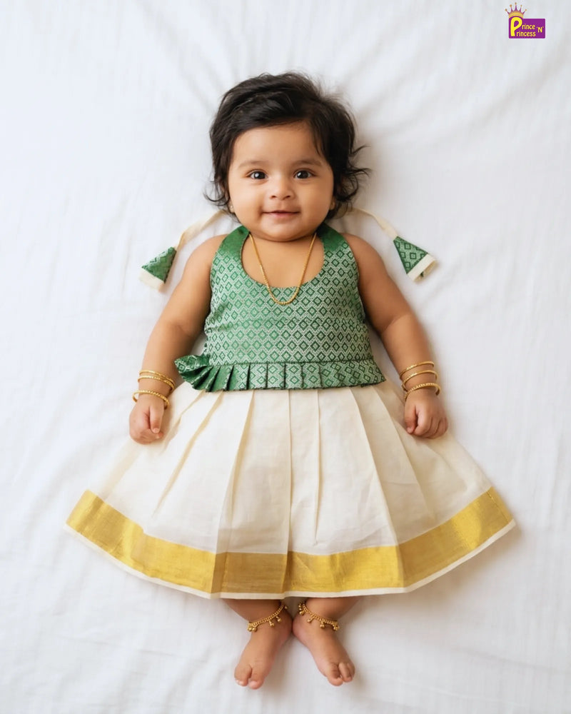 Baby wearing a green and white traditional outfit on a white background