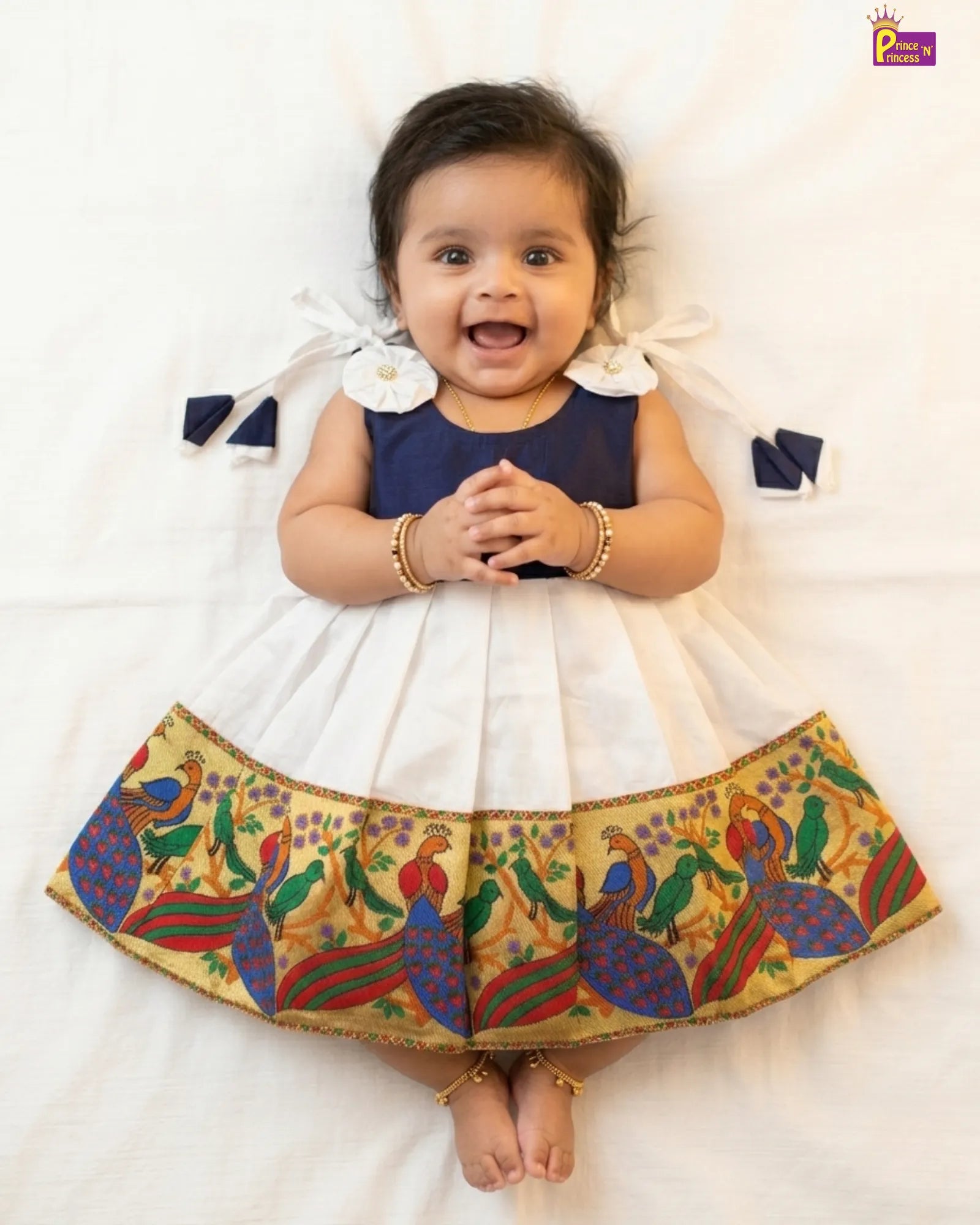 cute pose of white pattu frock baby wearing