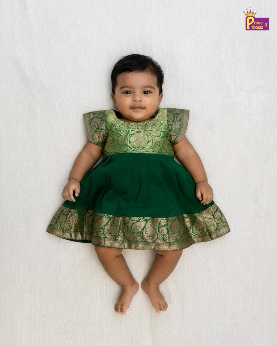 Baby wearing a green and gold dress on a white background - Prince N Princess