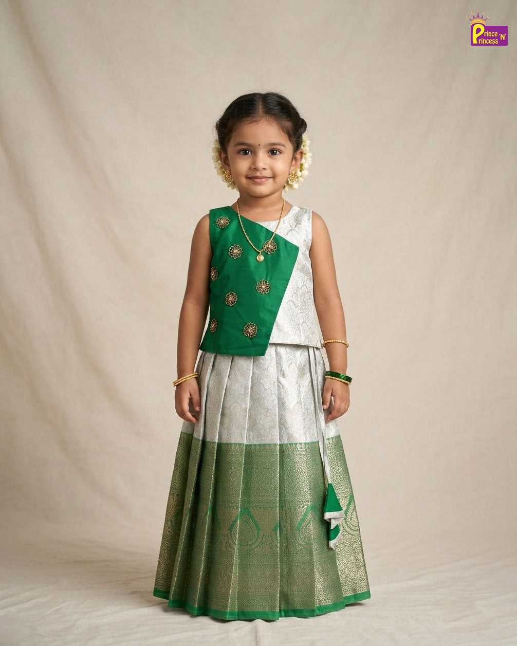 Young girl wearing a green and white traditional outfit on a beige background - Prince N Princess