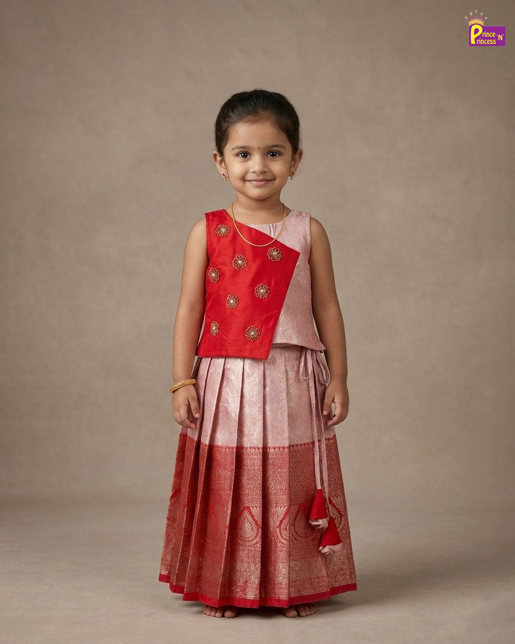 Young girl wearing a red and pink traditional outfit against a plain background - Prince N Princess
