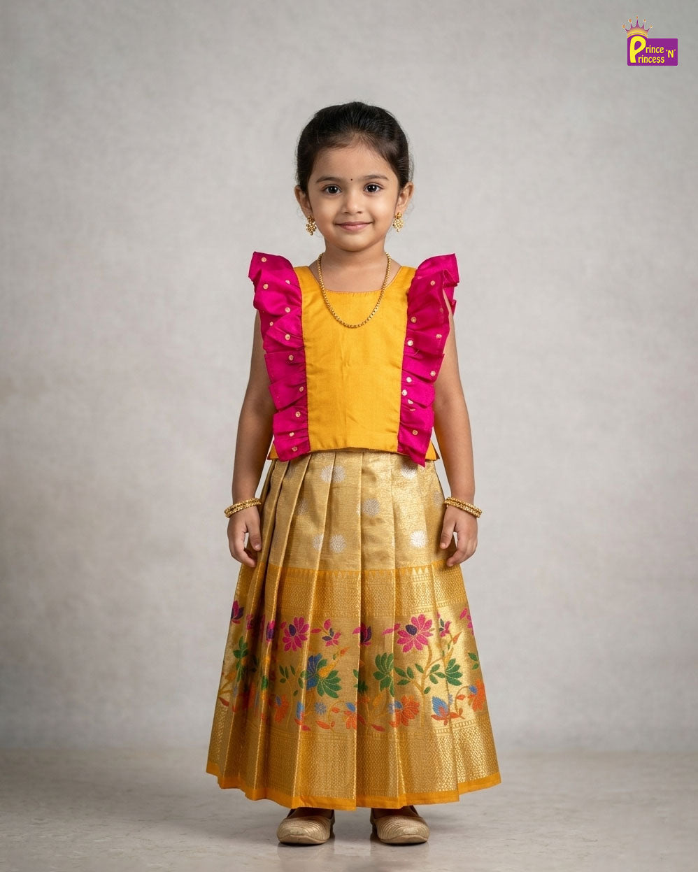 Young girl wearing a yellow outfit with pink sleeves against a plain background - Prince N Princess