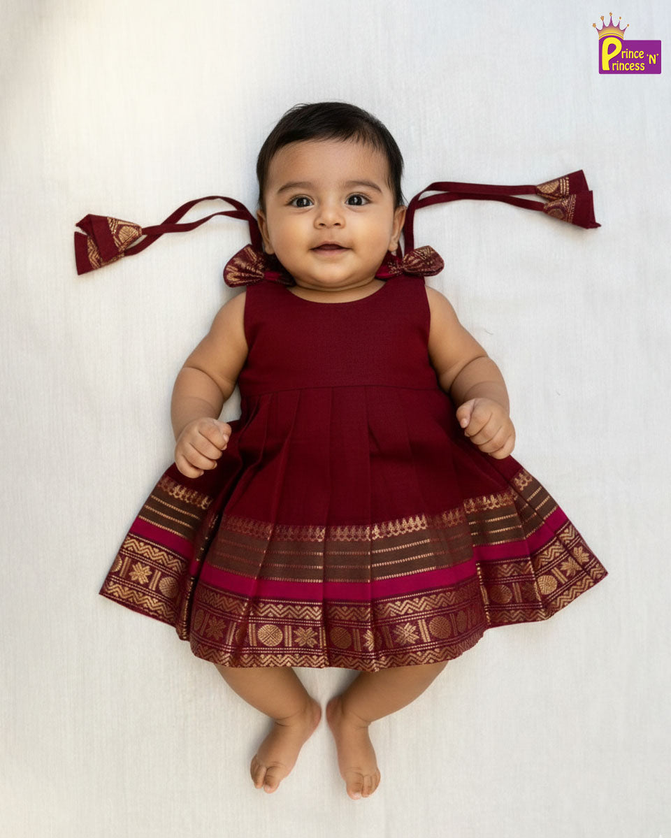Baby wearing a red traditional outfit with decorative elements on a white background - Prince N Princess