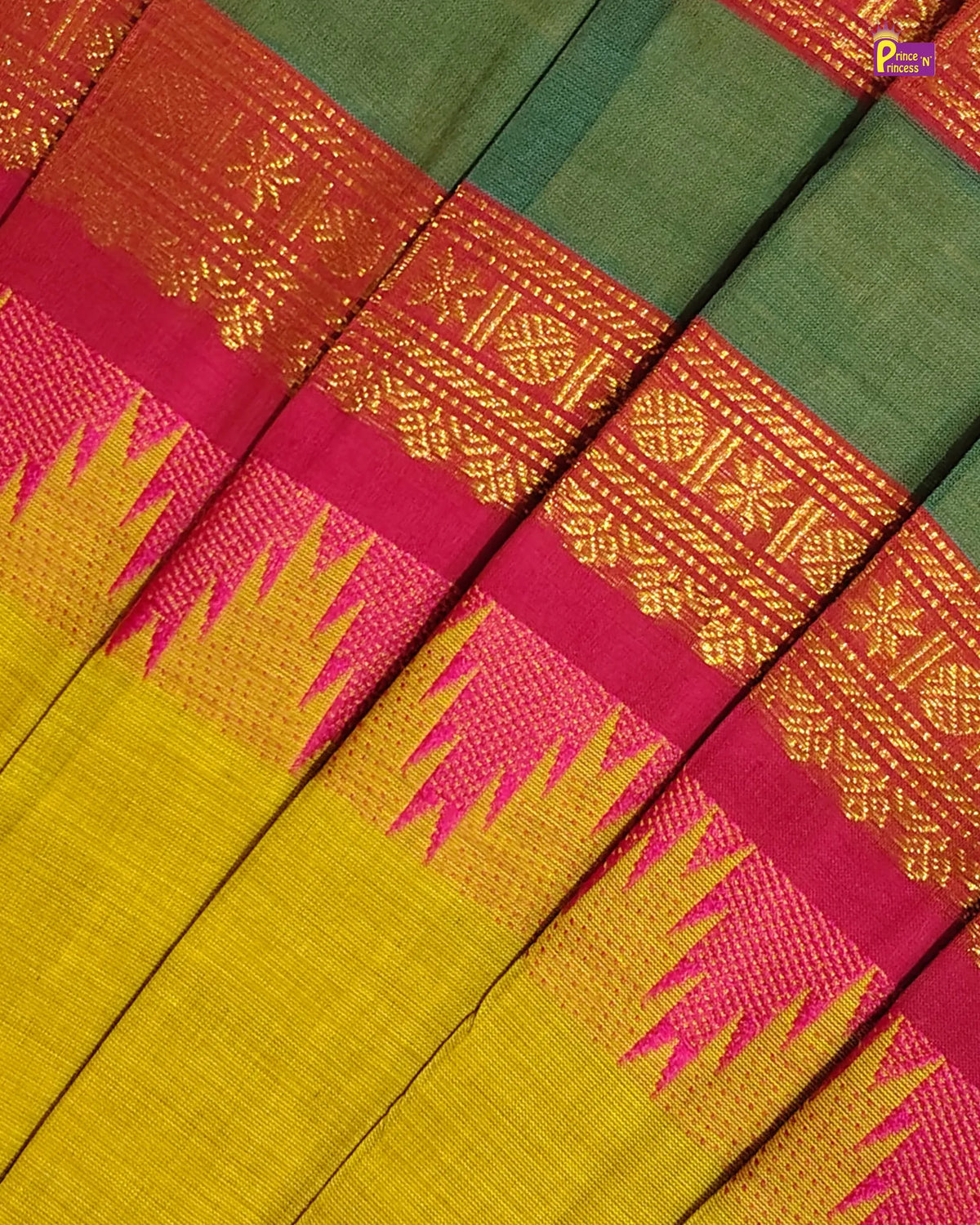 A close-up of a traditional Indian silk saree fabric, showing the rich green body, vibrant magenta border, golden metallic zari embroidery, and a yellow and magenta ikat-patterned pallu.