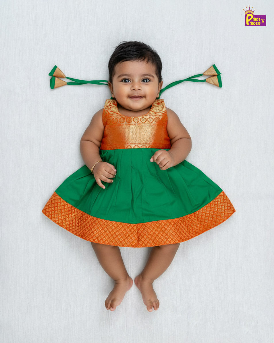 Baby wearing a green and orange traditional outfit with decorative elements on a white background - Prince N Princess
