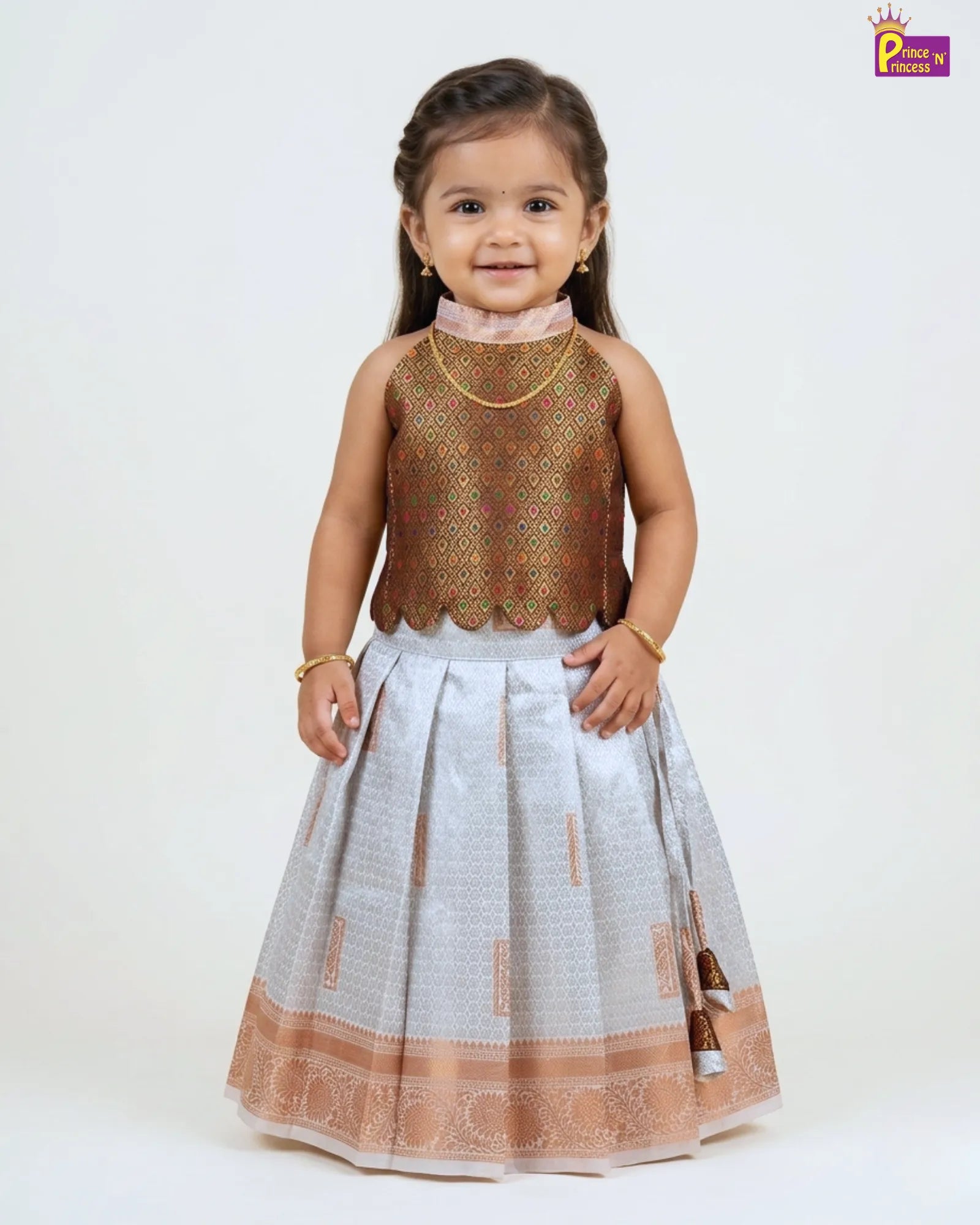 Young girl wearing a traditional outfit with a brown top and white skirt on a white background