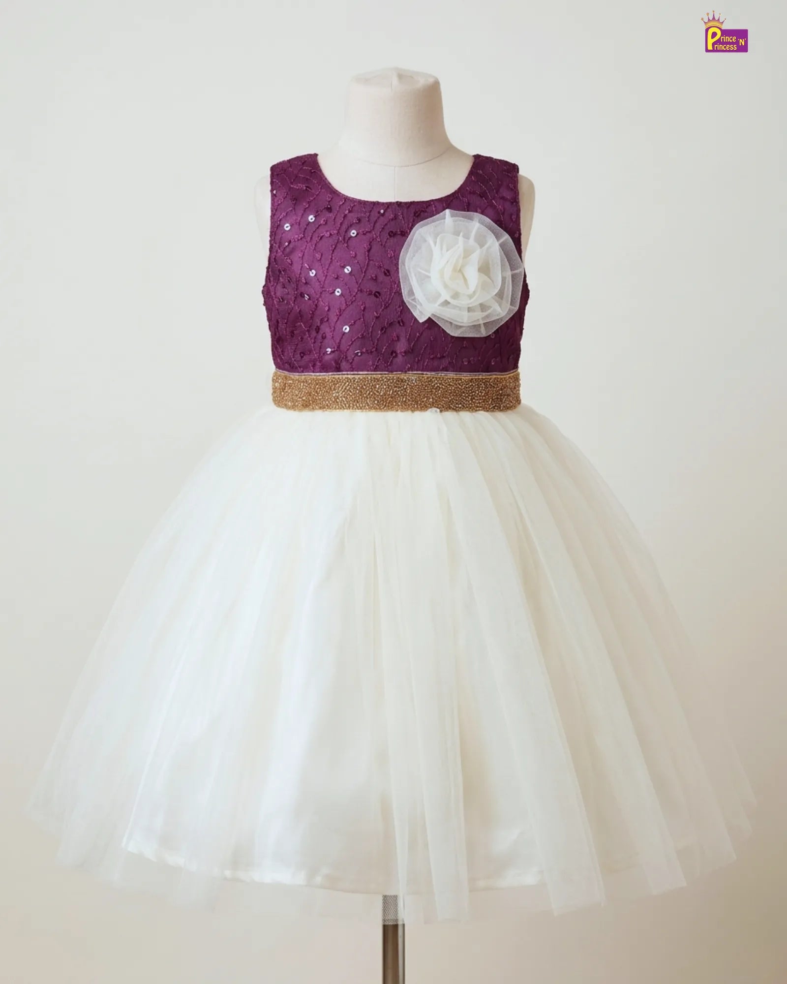 Children's dress with purple top and white skirt on a mannequin against a white background