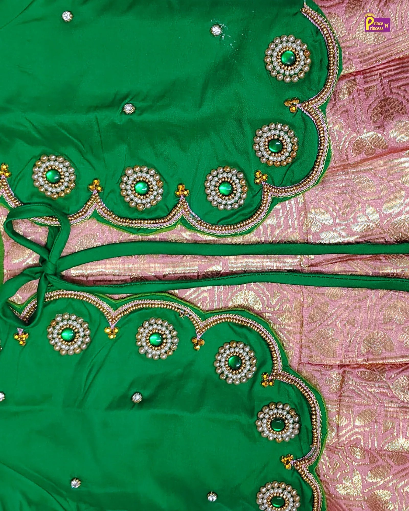 Green embroidered fabric with pink background