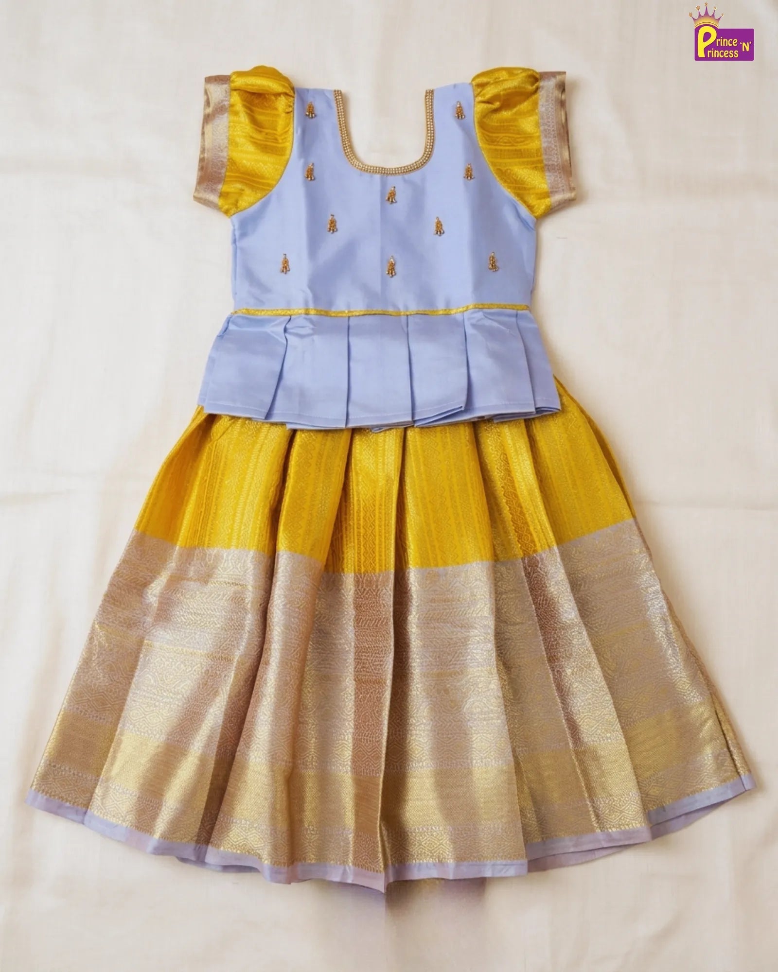 Yellow and blue traditional outfit on a beige background