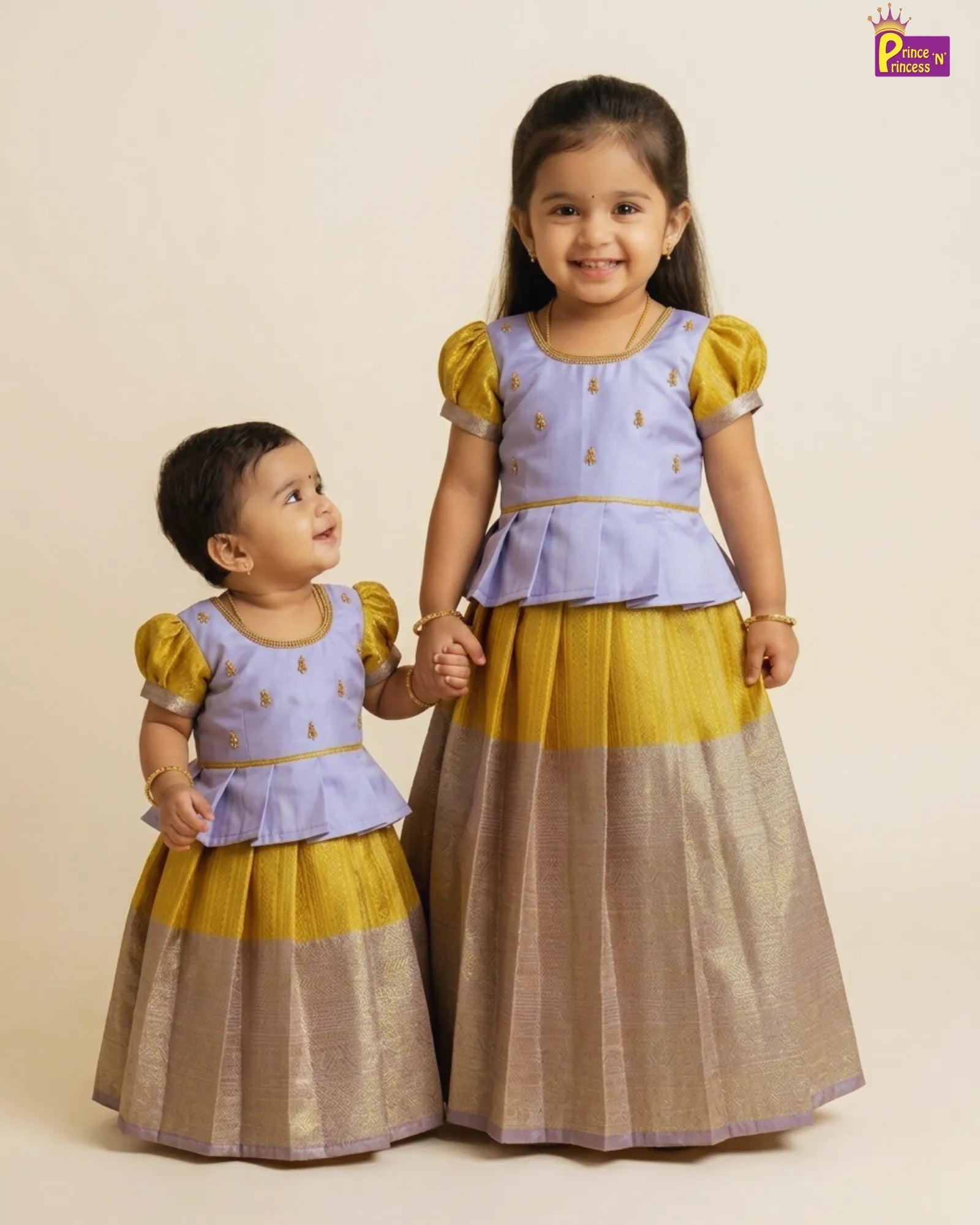 Two children wearing matching traditional outfits with a beige background