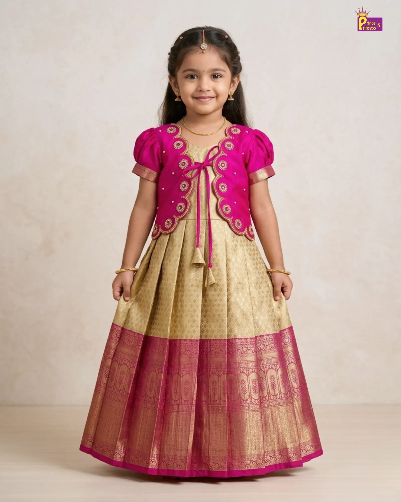 Young girl wearing a traditional outfit with pink and gold details on a beige background
