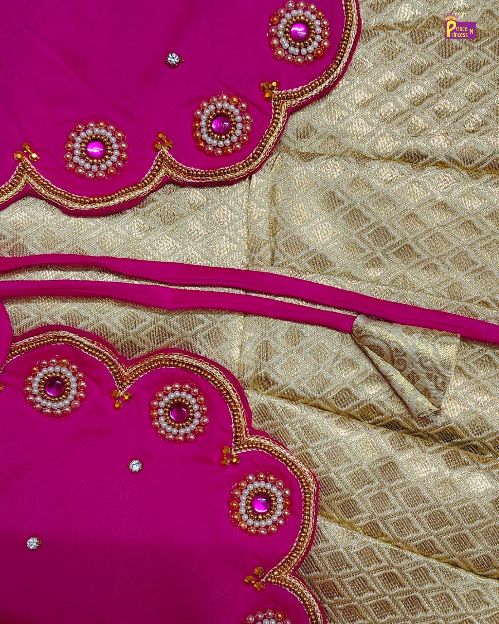 Saree with pink and gold embroidery on a beige fabric background