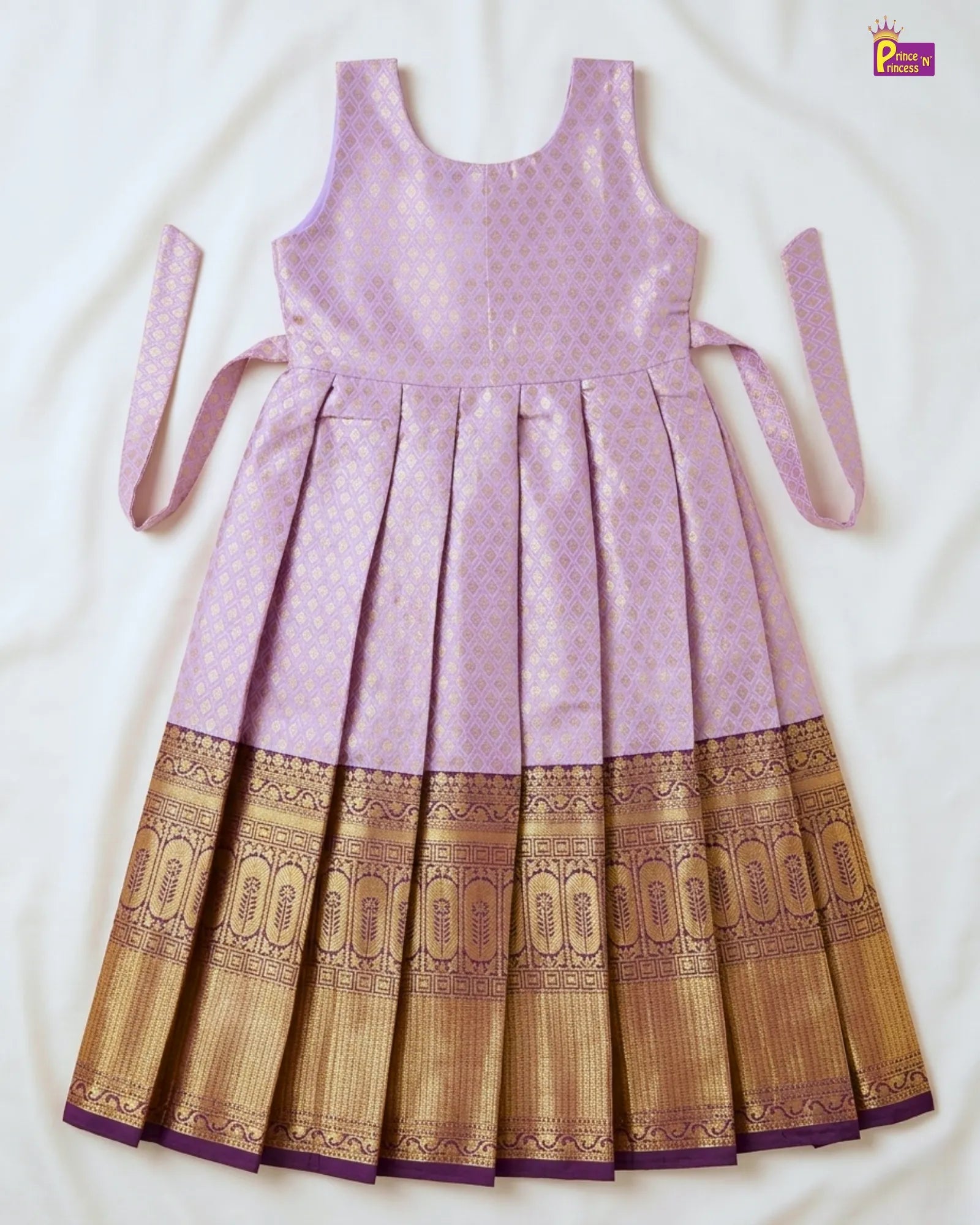 Purple and gold dress with a patterned hem on a white background
