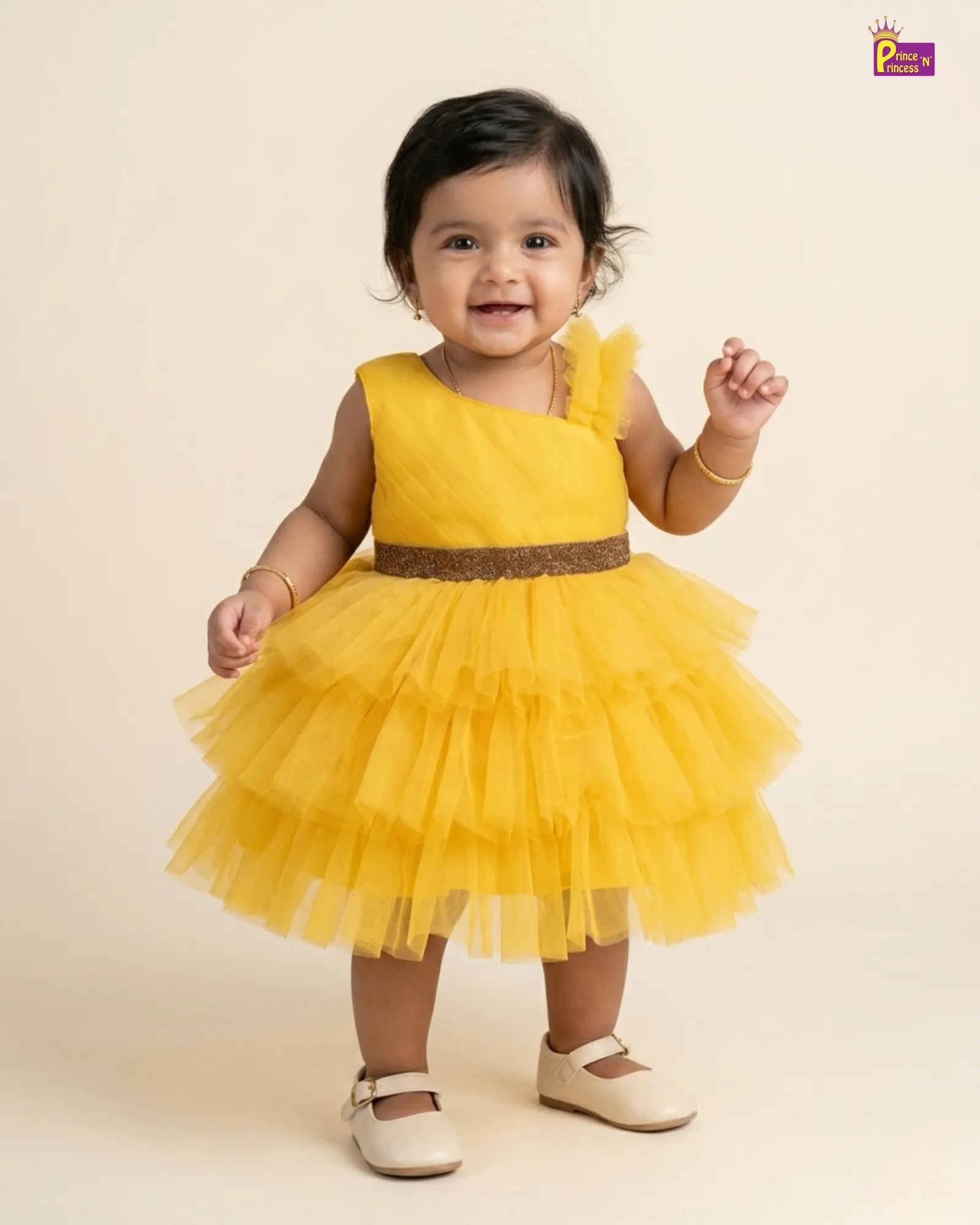 Child wearing a yellow dress with a brown belt on a beige background