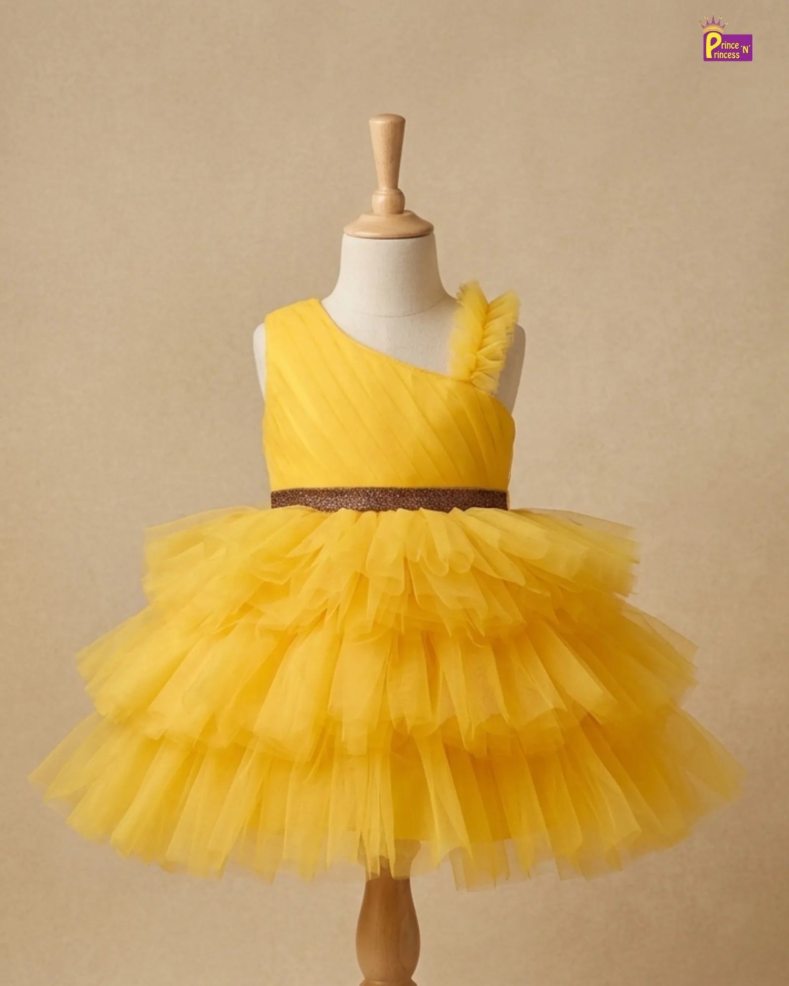 Yellow tutu dress on a mannequin against a beige background