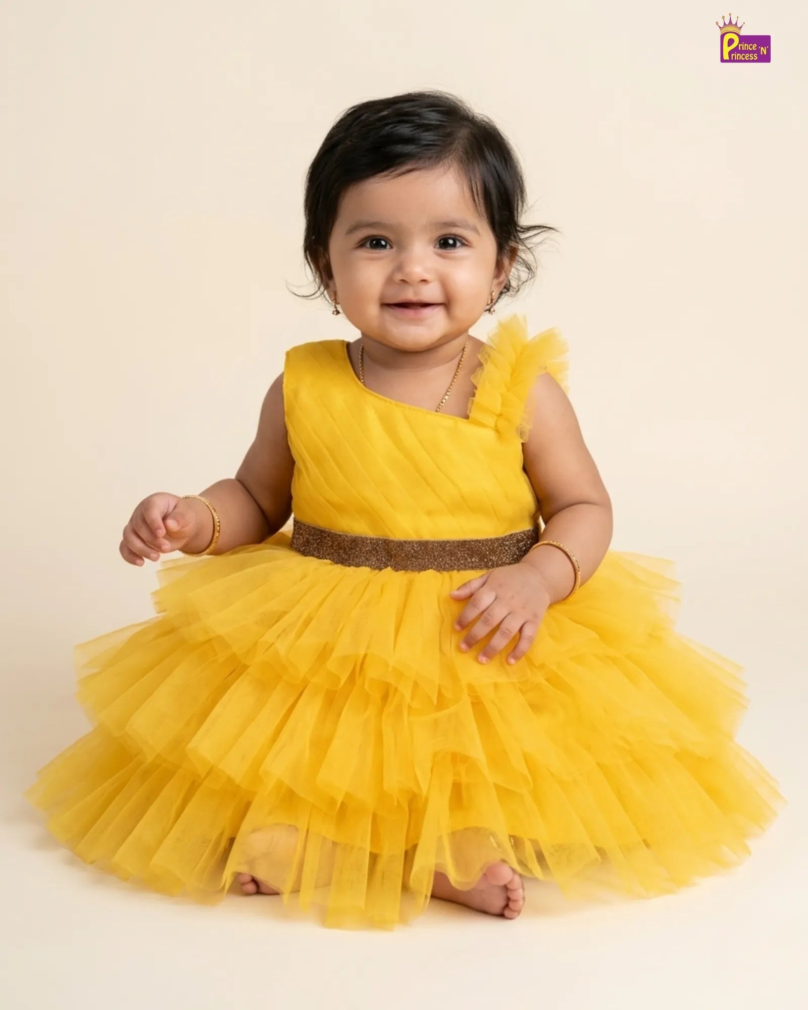 Child wearing a yellow dress with a brown belt on a beige background