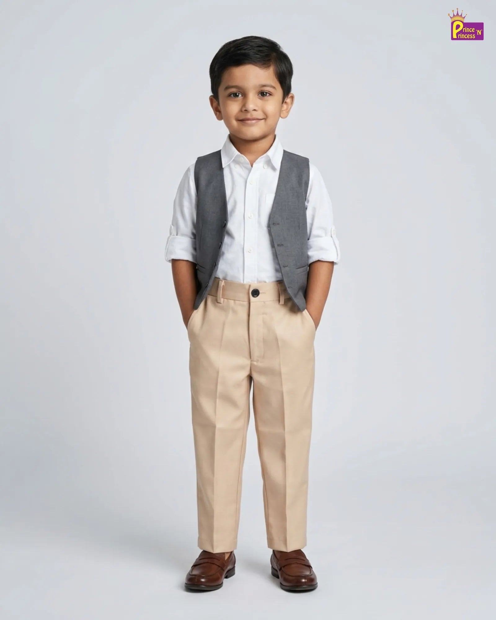 Young boy wearing a white shirt, gray vest, beige pants, and brown shoes on a light gray background.