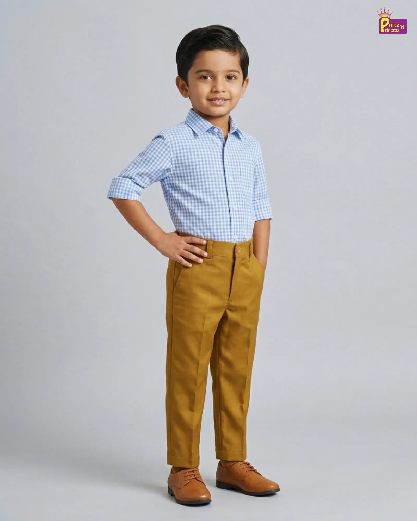 Child wearing a checkered shirt and mustard pants on a gray background