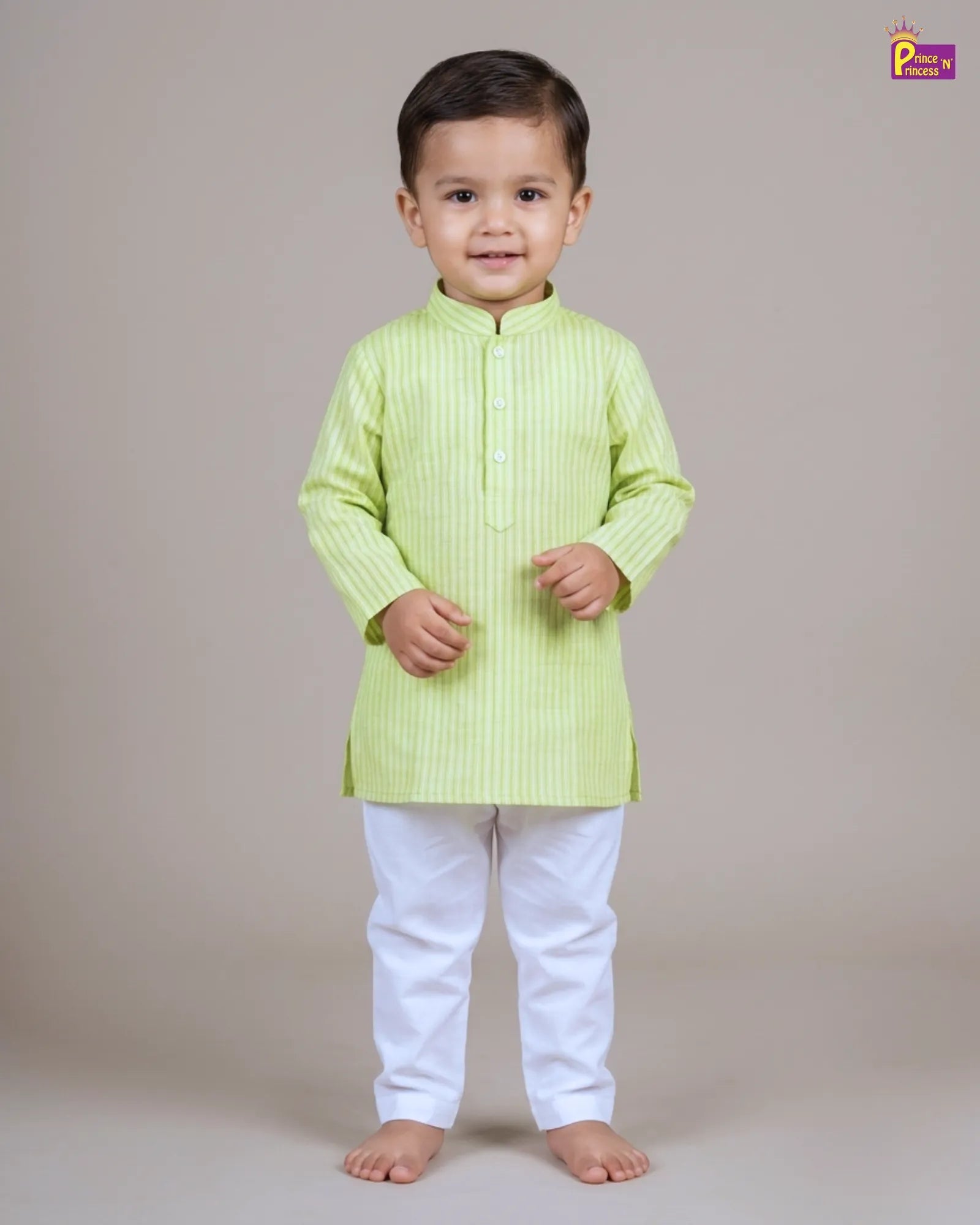 Child wearing a light green kurta with white pants on a plain background
