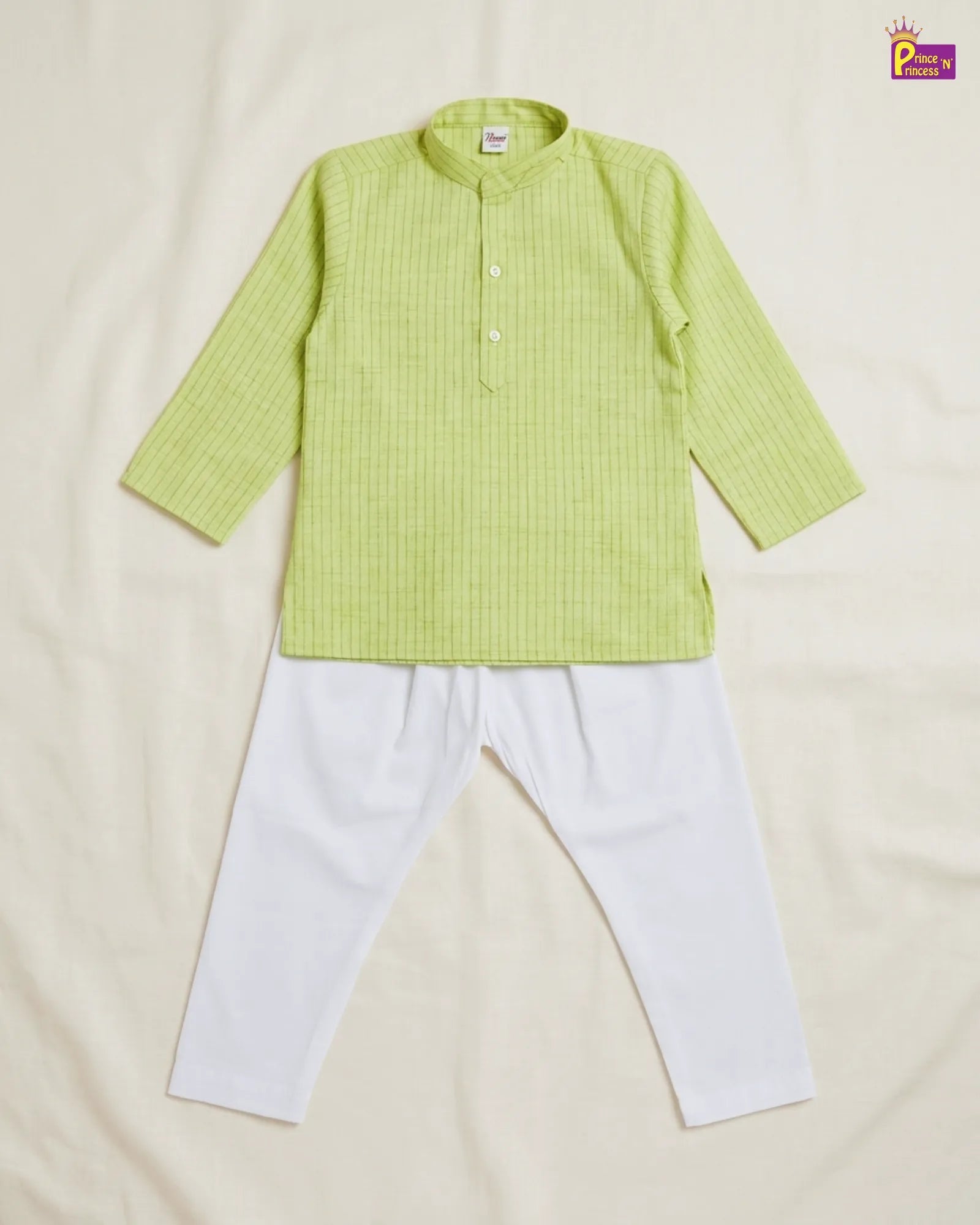 Green shirt and white pants set on a beige background