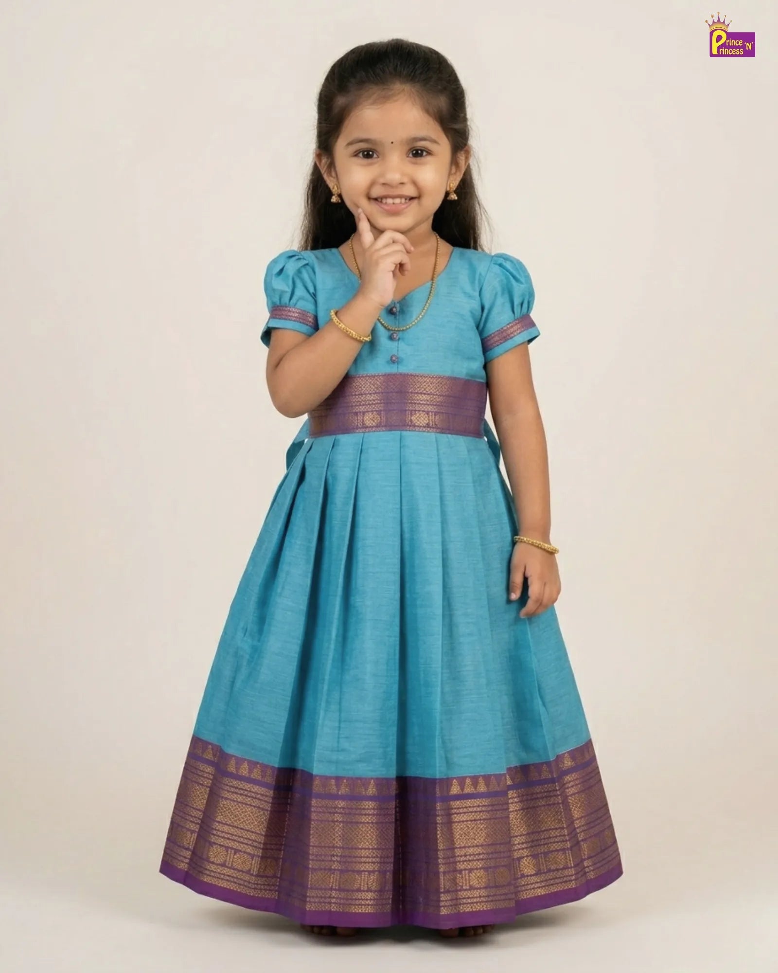 Young girl wearing a blue and purple traditional dress on a white background