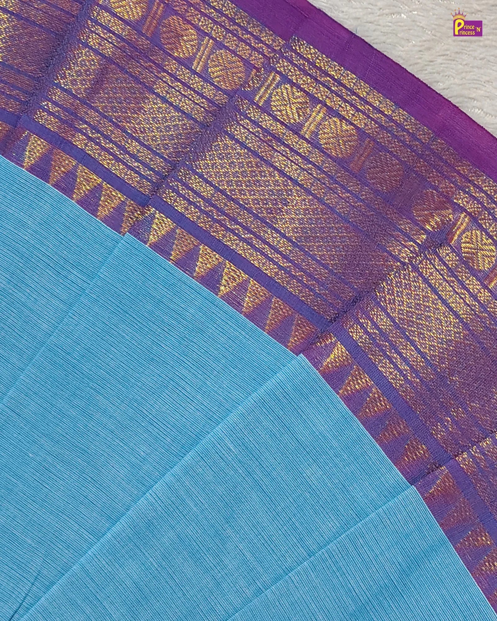 Blue fabric with a purple border featuring intricate gold patterns