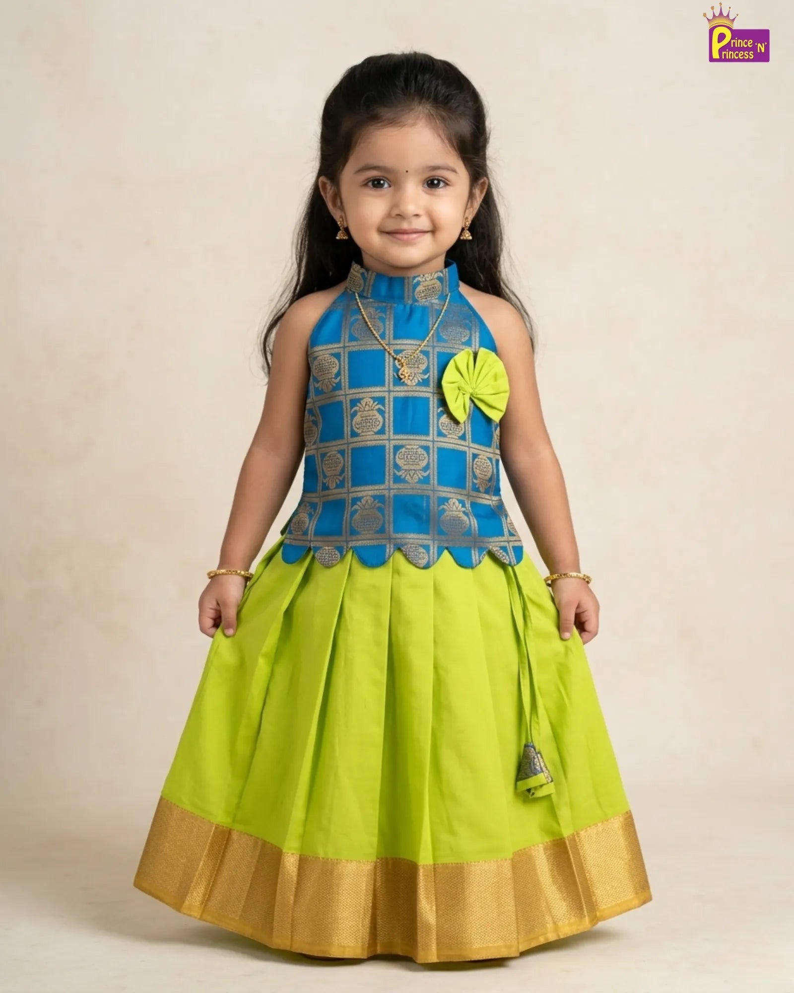 Young girl wearing a blue and green traditional outfit with a beige background