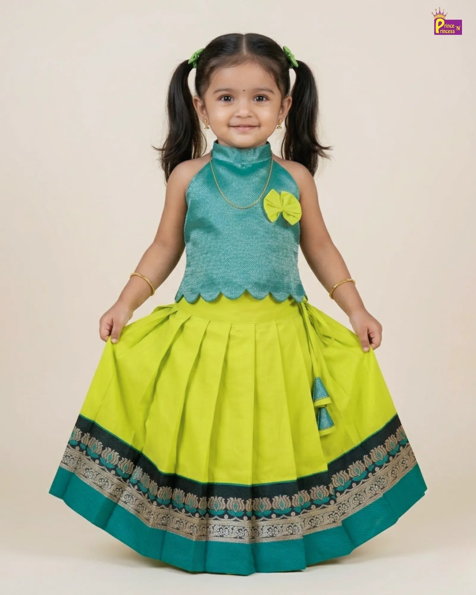 Young girl wearing a green and blue traditional outfit with floral details on a beige background