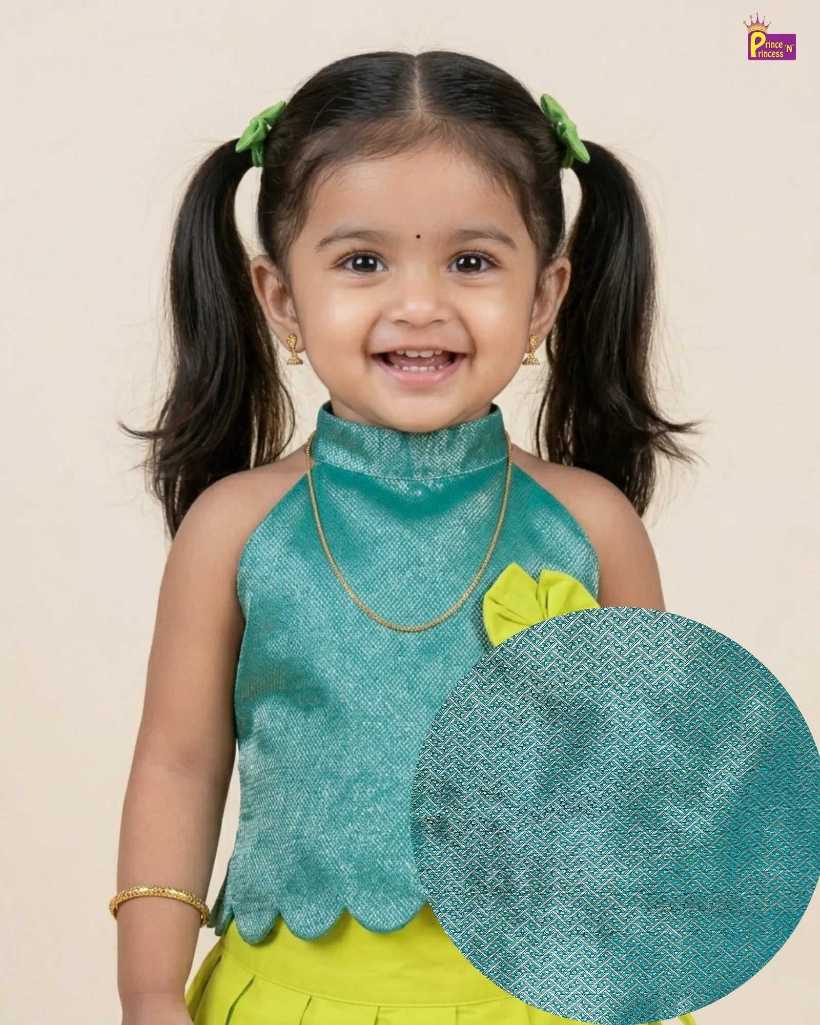 Young girl in a green and yellow traditional outfit with a matching green headscarf.