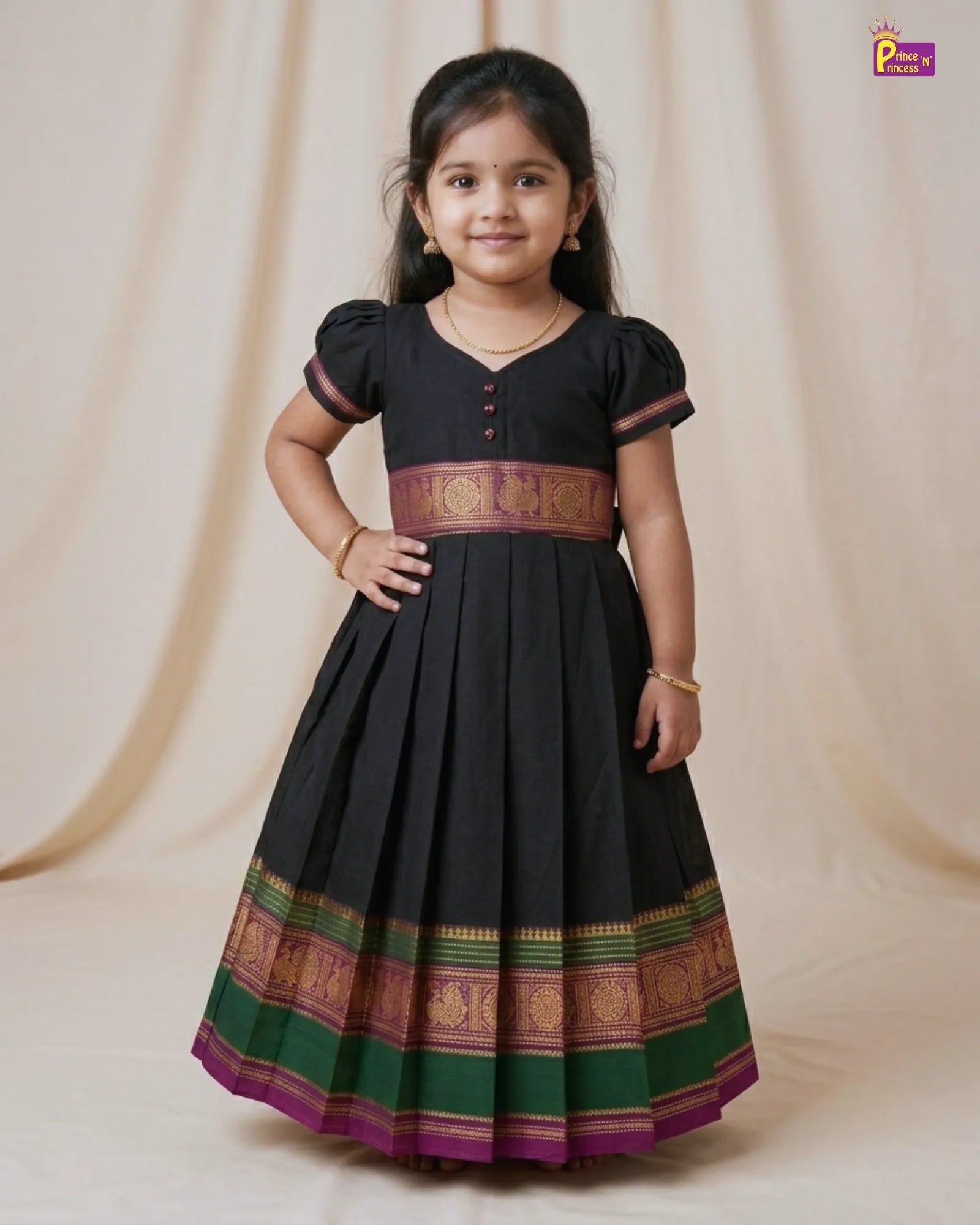 Young girl wearing a black traditional dress with colorful patterns on a beige background