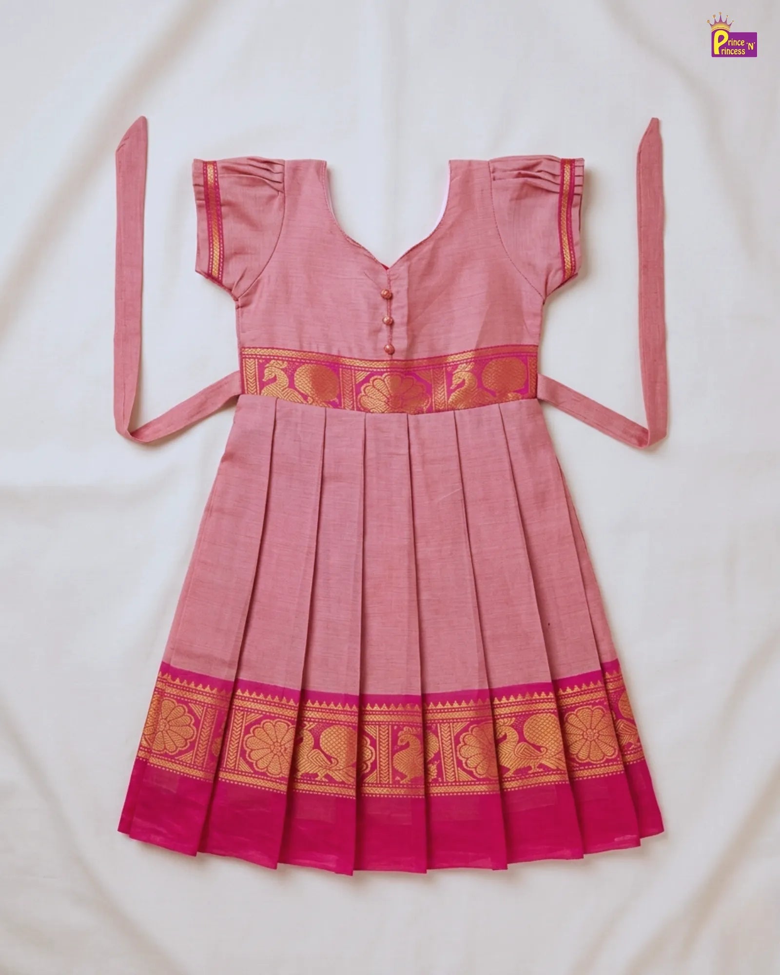 Pink traditional dress with gold patterns on a white background