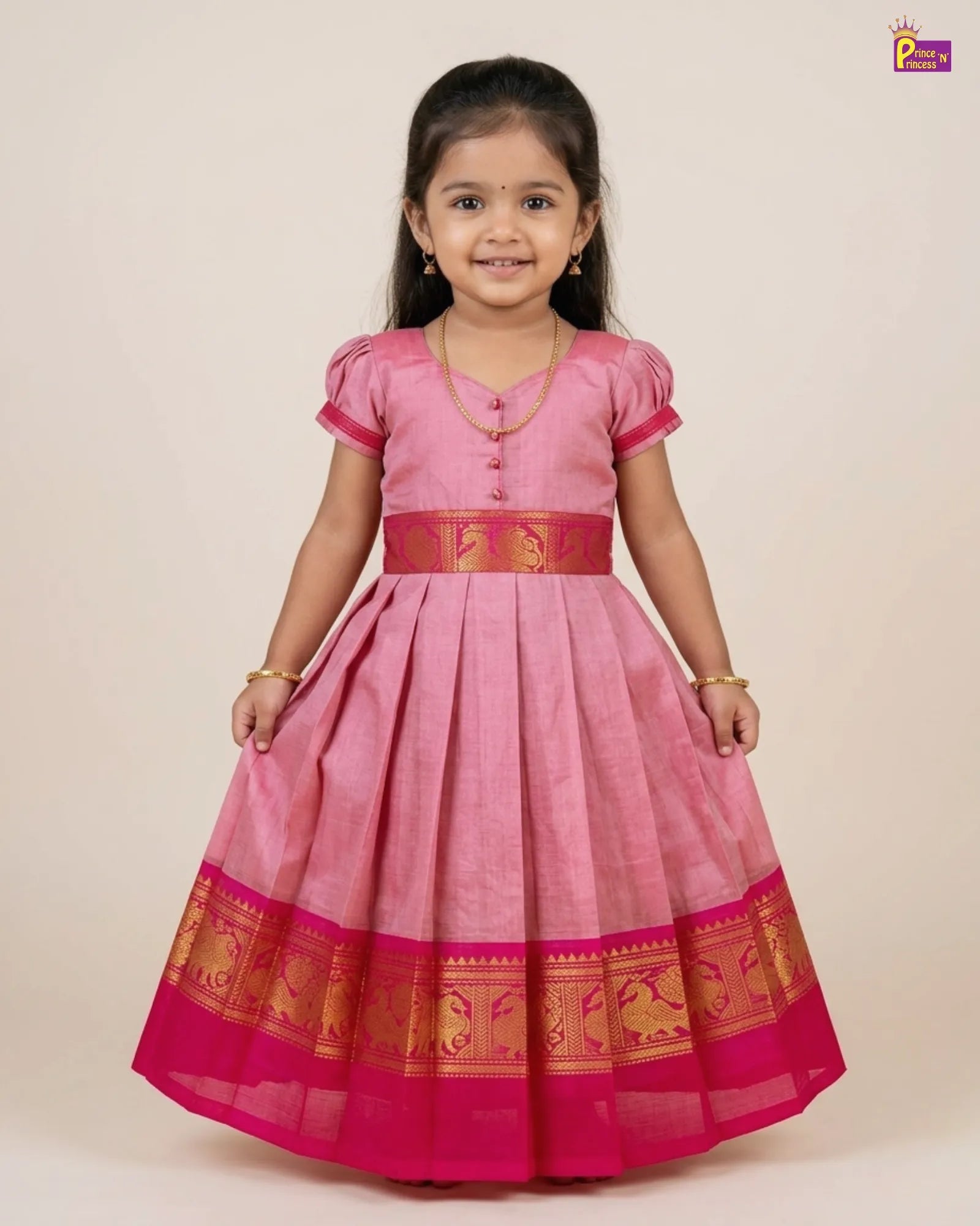 Young girl wearing a pink traditional dress with gold accents on a beige background