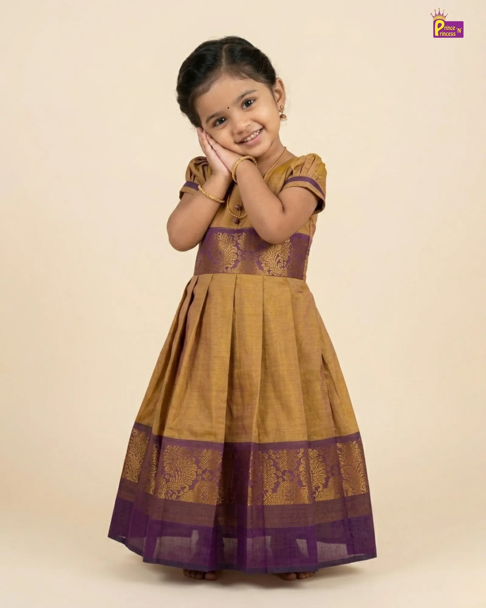 Young girl wearing a traditional outfit with purple and gold design on a beige background