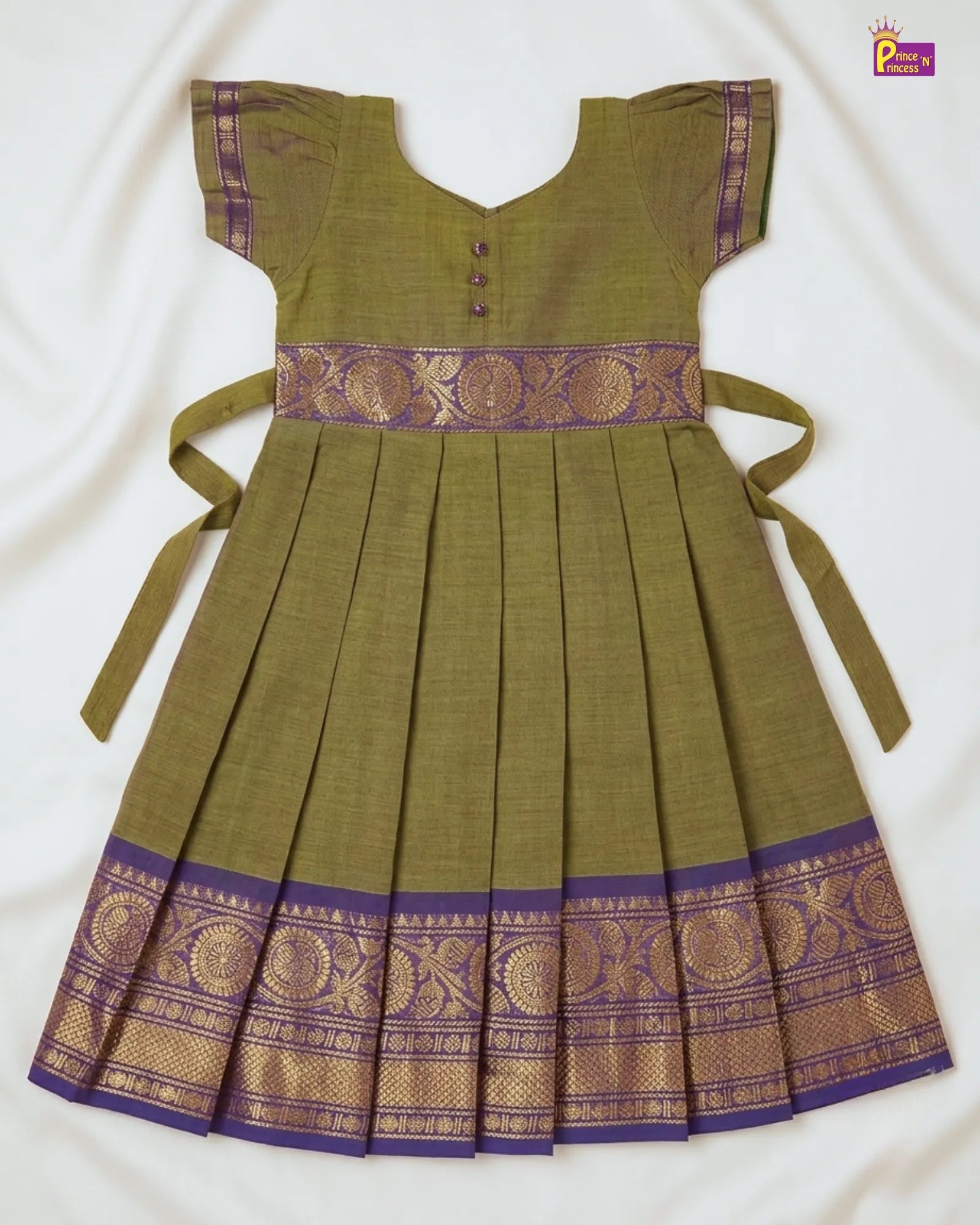 Green dress with purple and gold accents on a white background