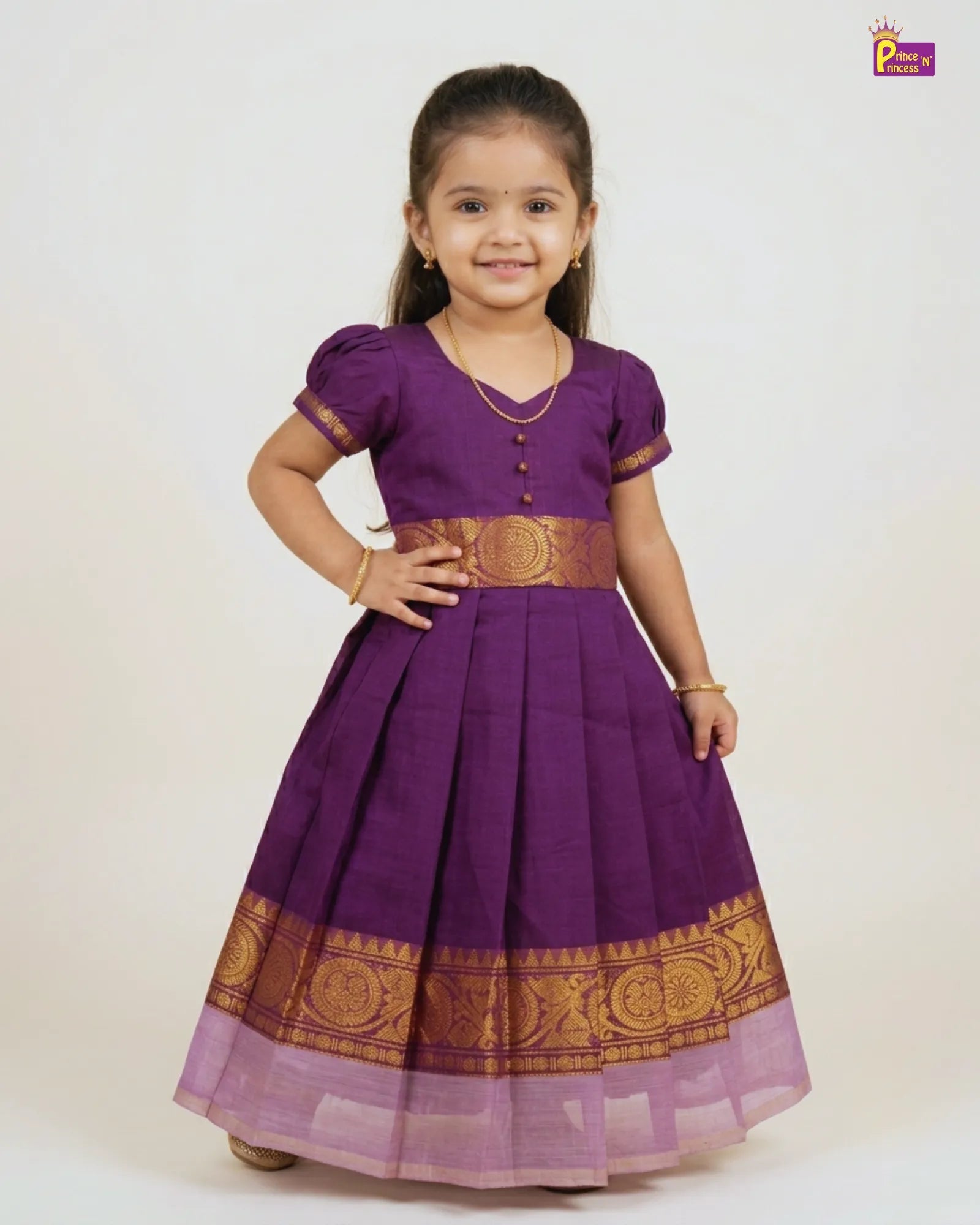 Young girl wearing a purple traditional outfit with gold accents on a white background