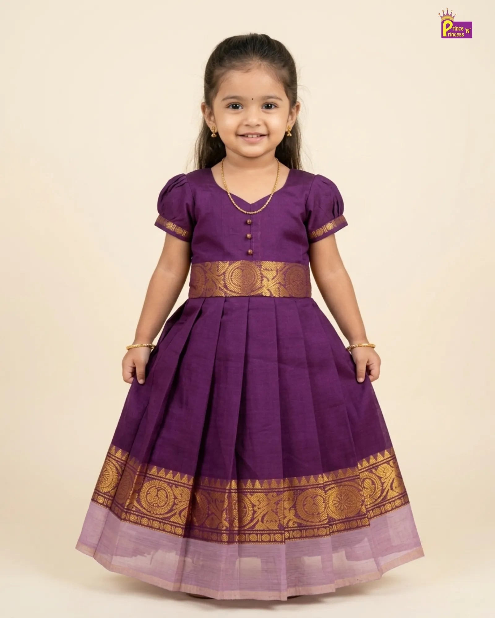 Young girl wearing a purple traditional dress with gold accents on a beige background