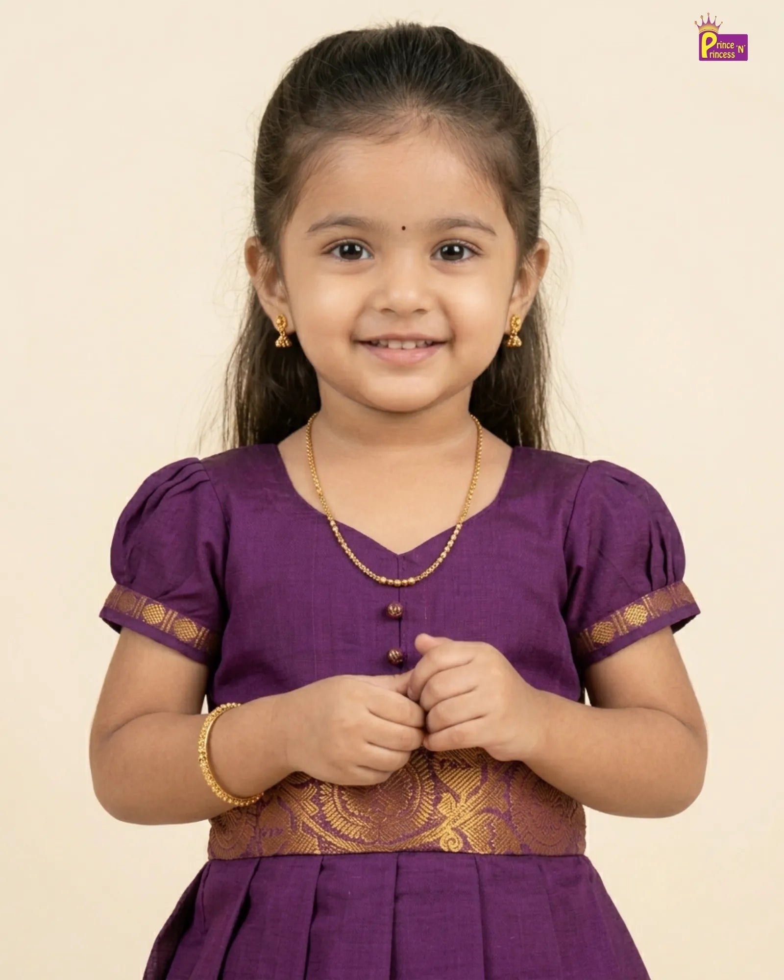 Young girl wearing a purple traditional outfit with gold accents on a beige background