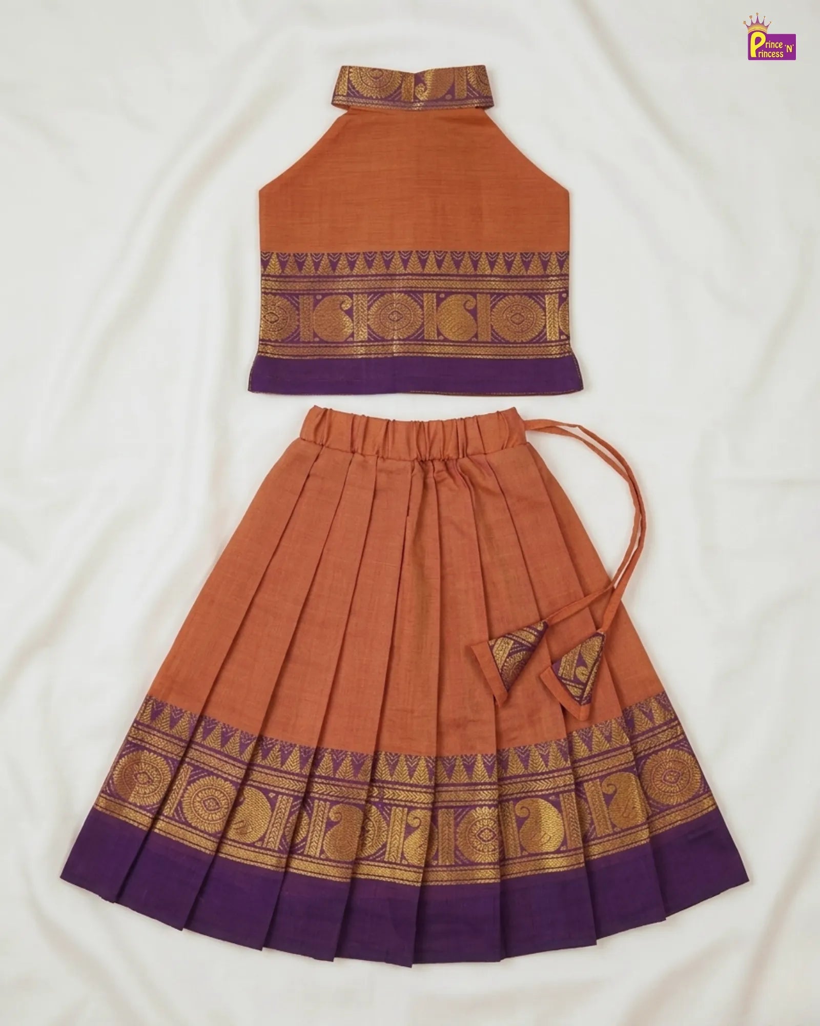 Traditional outfit with orange top and skirt on a white background