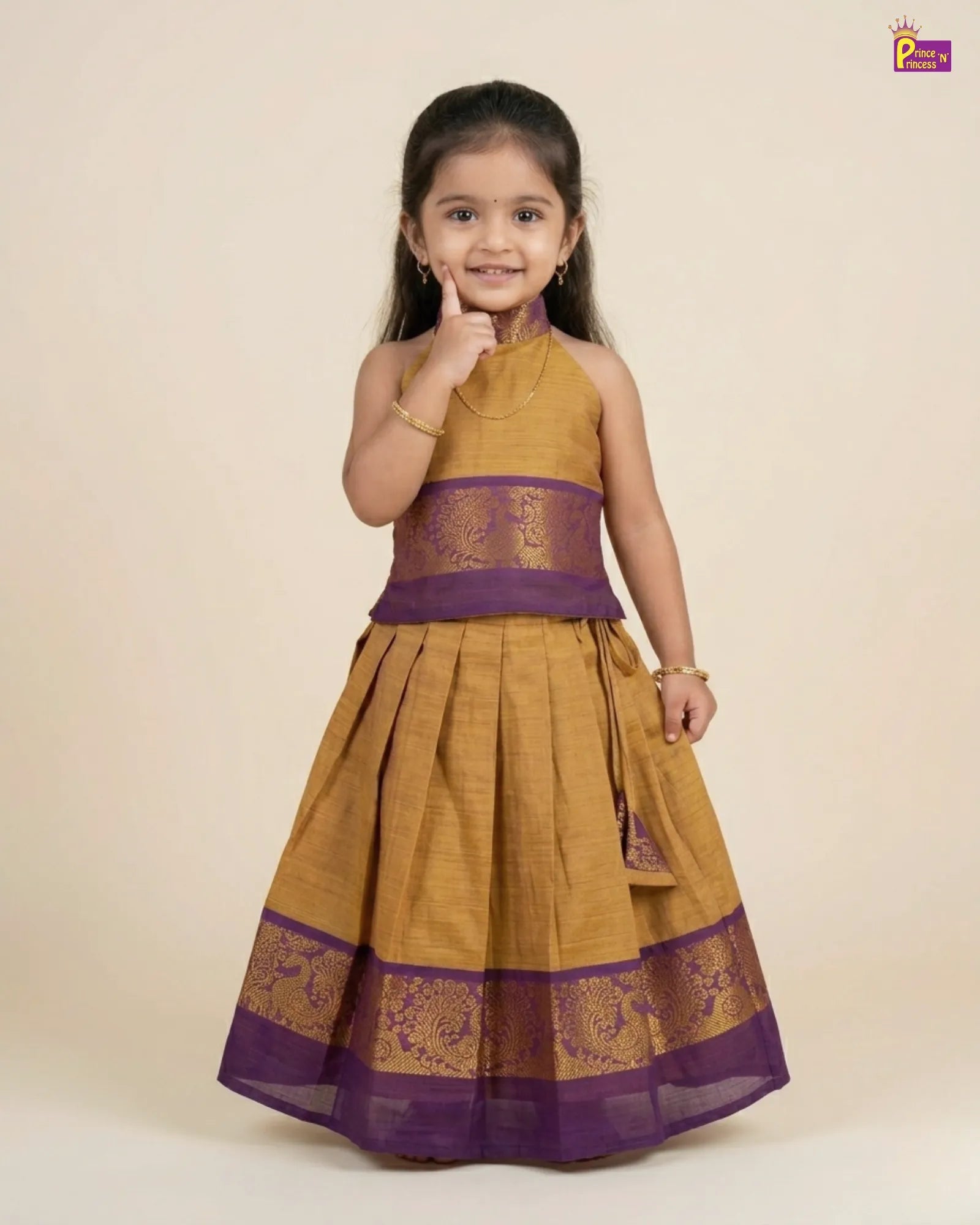 Young girl wearing a mustard yellow and purple traditional outfit on a beige background