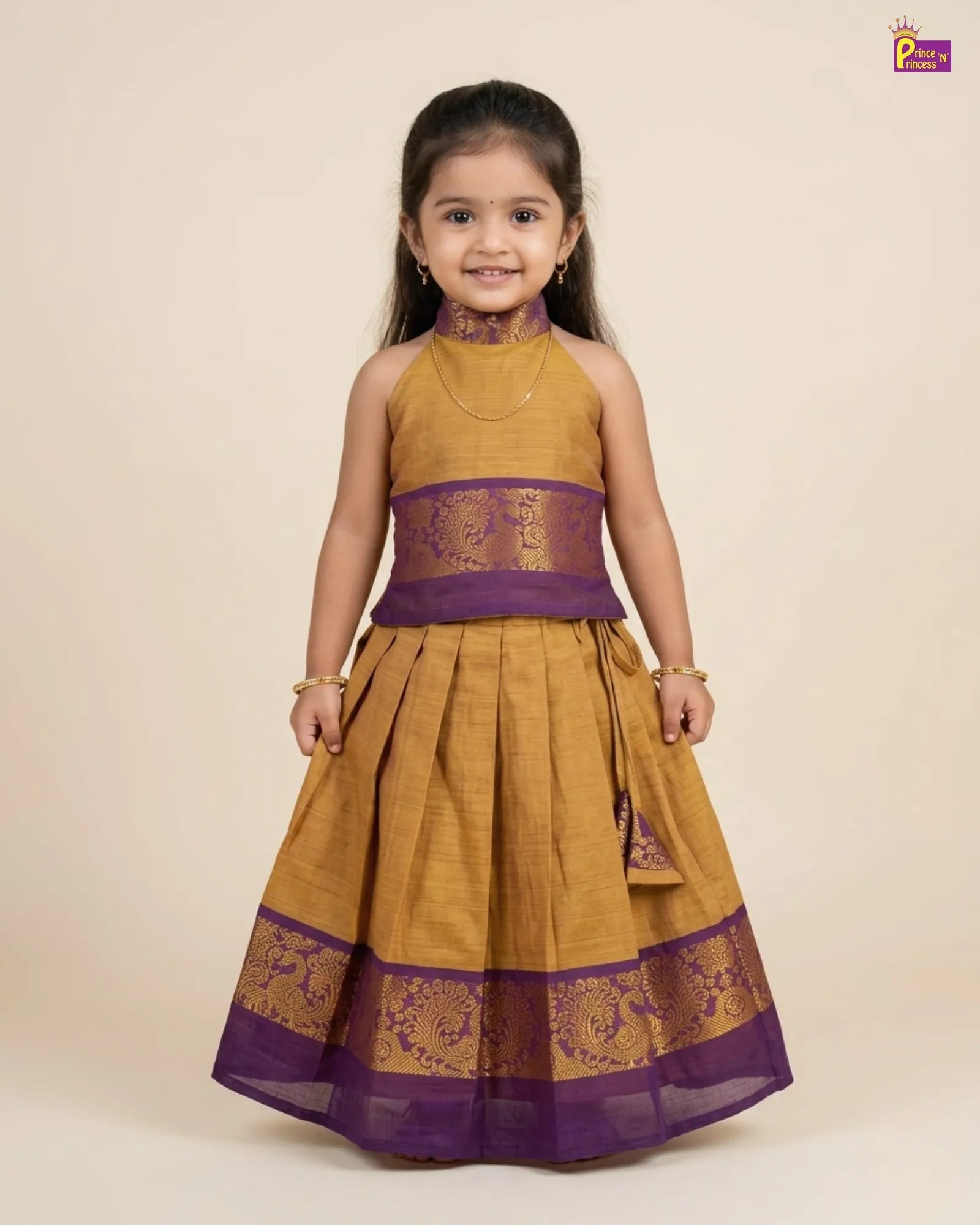 Young girl wearing a mustard yellow and purple traditional outfit on a beige background