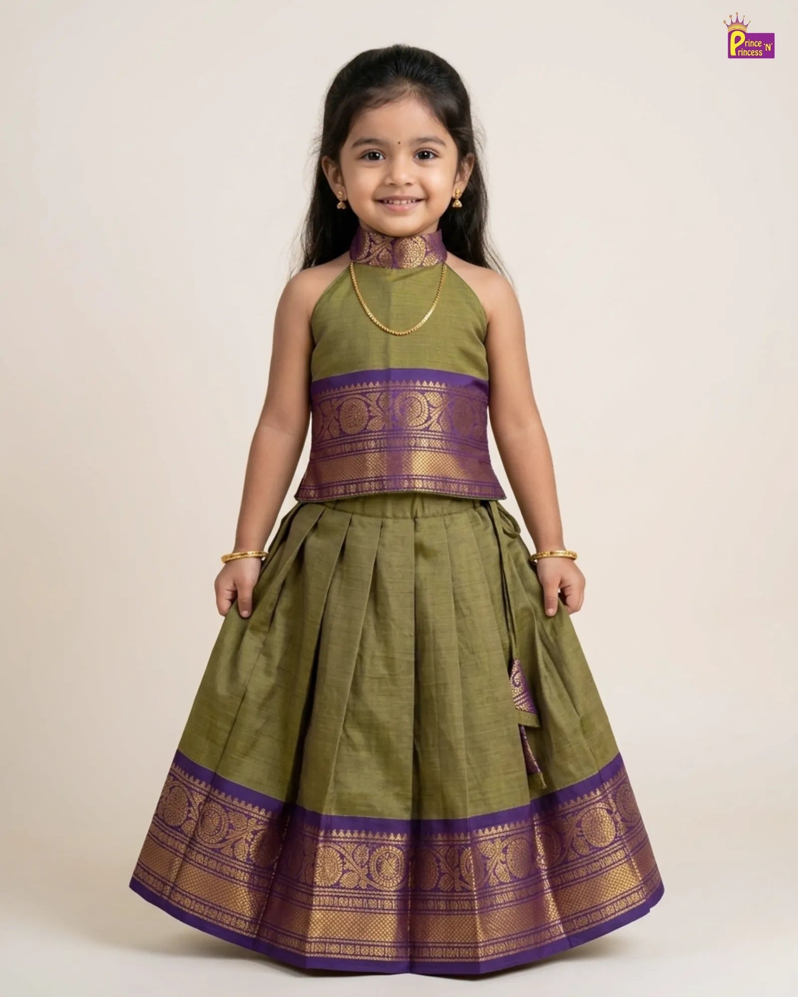 Young girl wearing a green and purple traditional outfit on a beige background