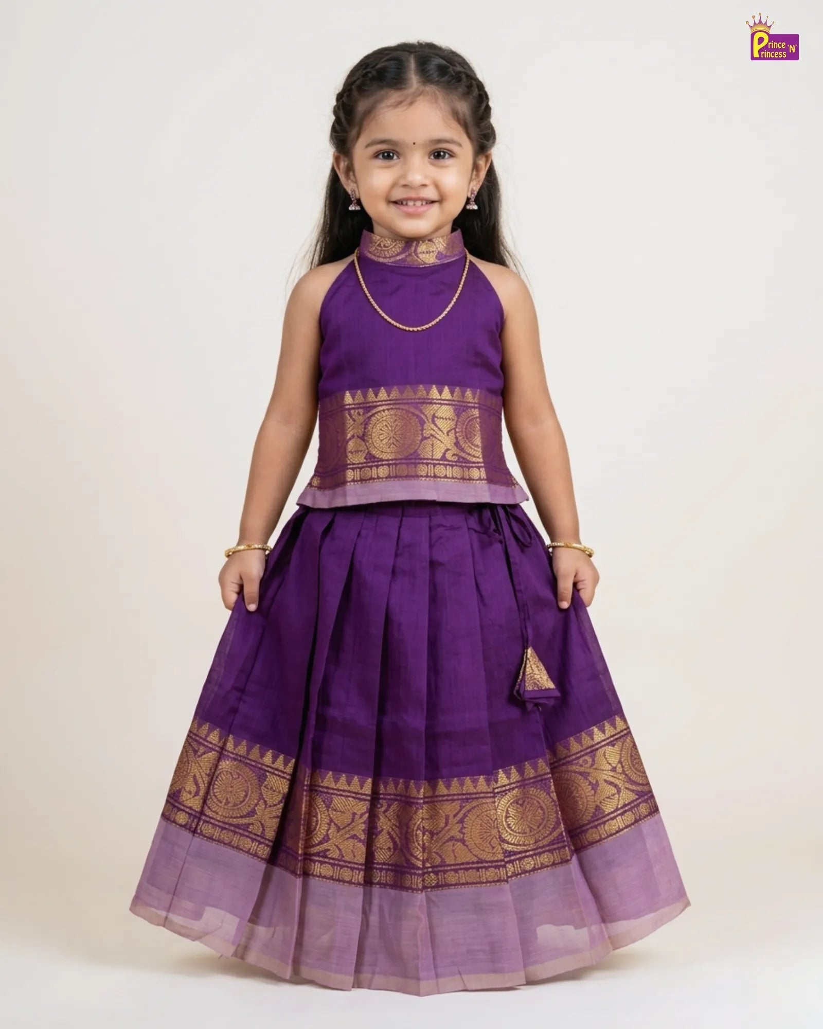 Young girl wearing a purple traditional outfit with gold patterns on a white background