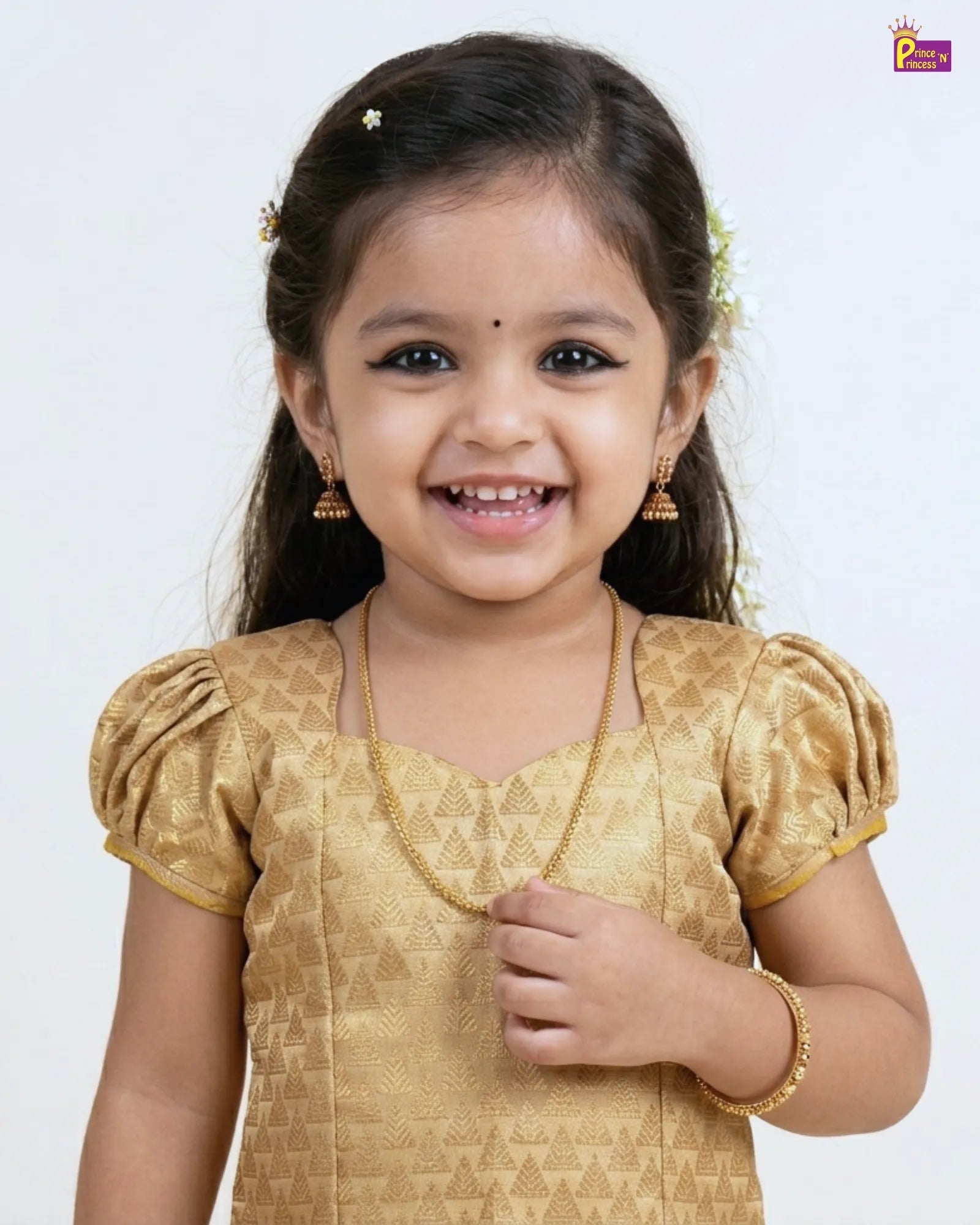 Young girl wearing a gold traditional outfit with a plain background