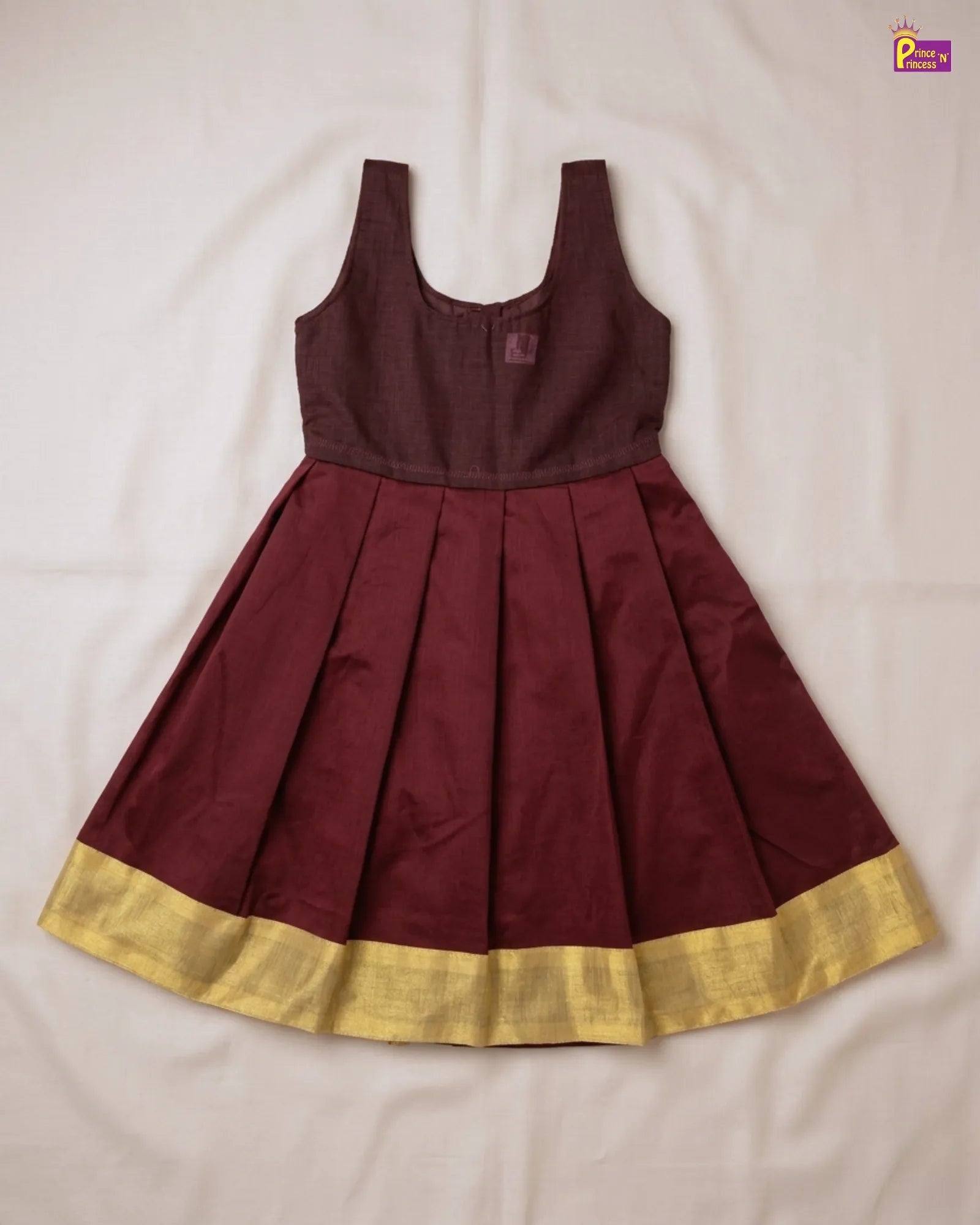 Maroon dress with gold hem on a white background
