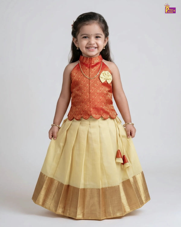 Young girl wearing a traditional outfit with an orange top and yellow skirt on a white background