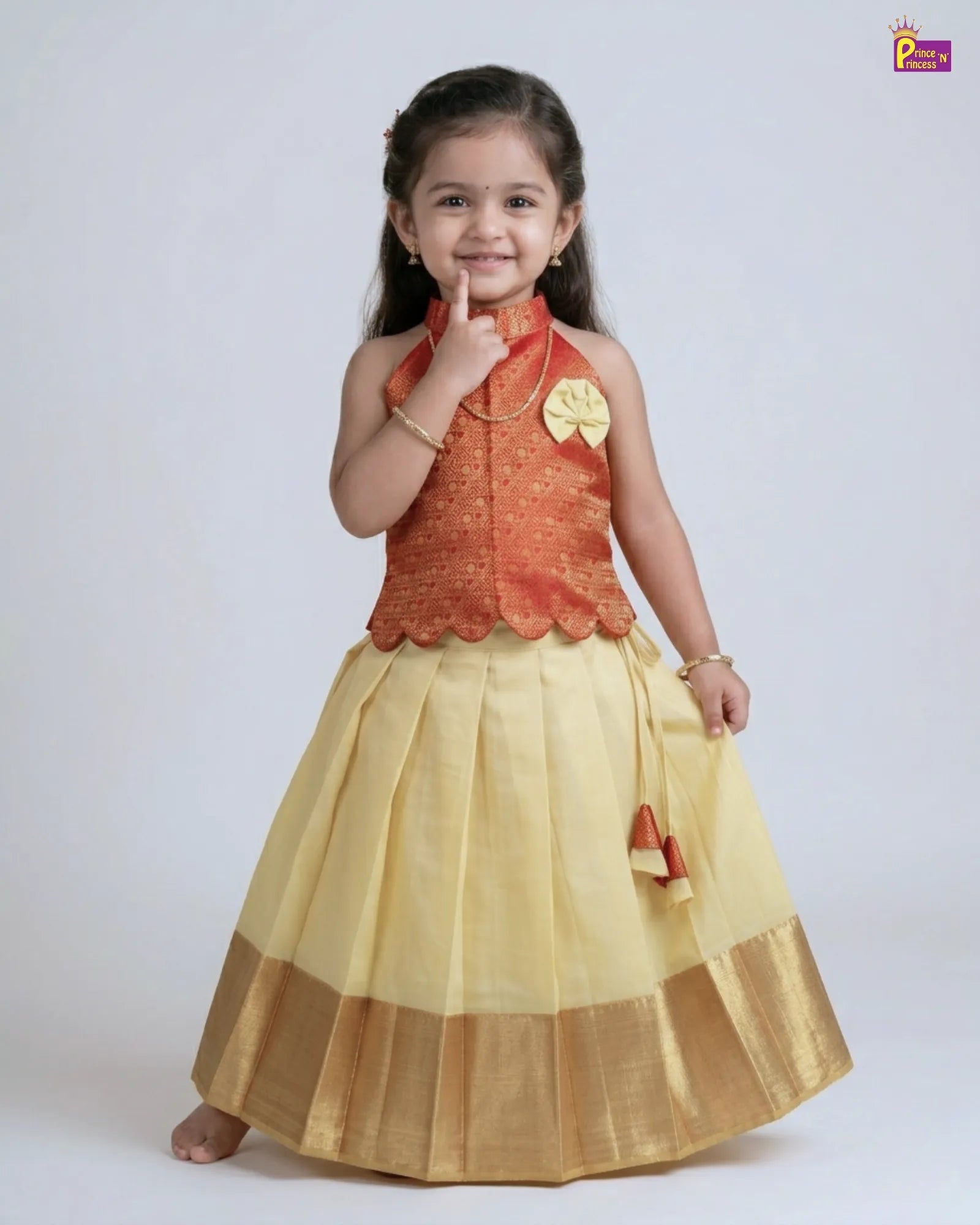 Young girl wearing a traditional outfit with a red top and yellow skirt on a white background