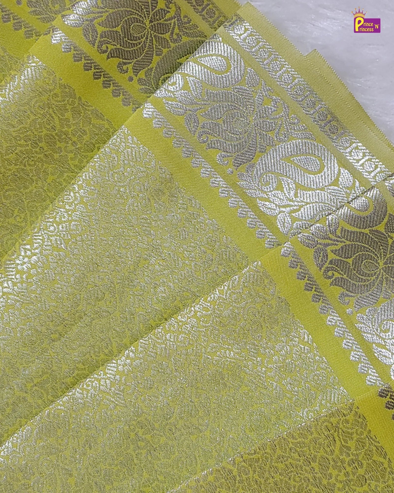 Decorative fabric with intricate patterns in green and silver.