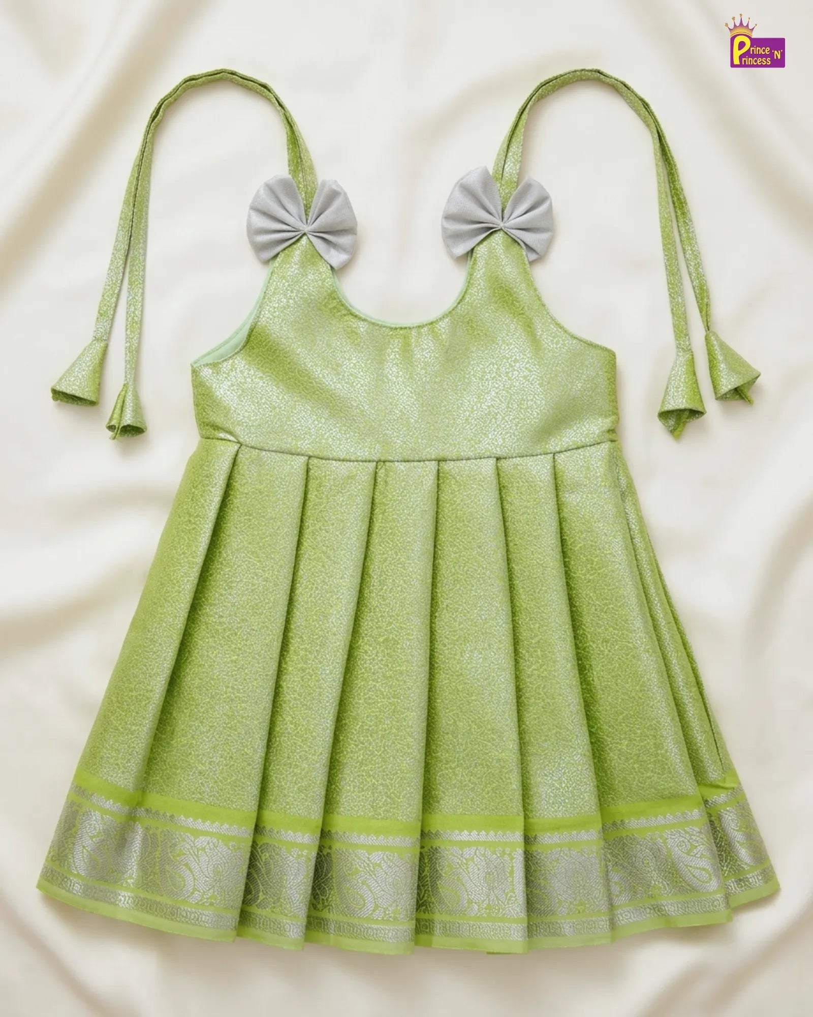 Green dress with bow straps on a white background