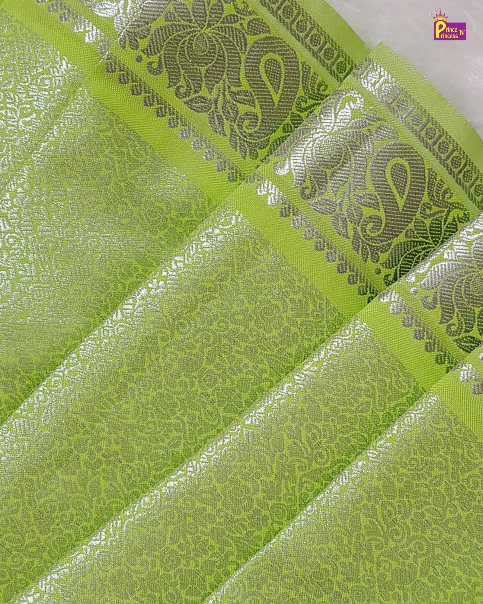 Green fabric with silver embroidery patterns